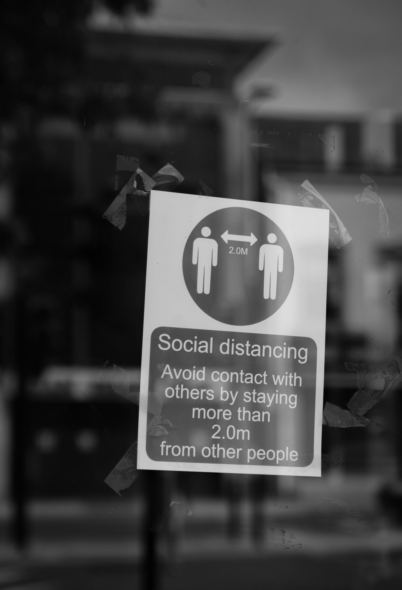 social distancing sign on window