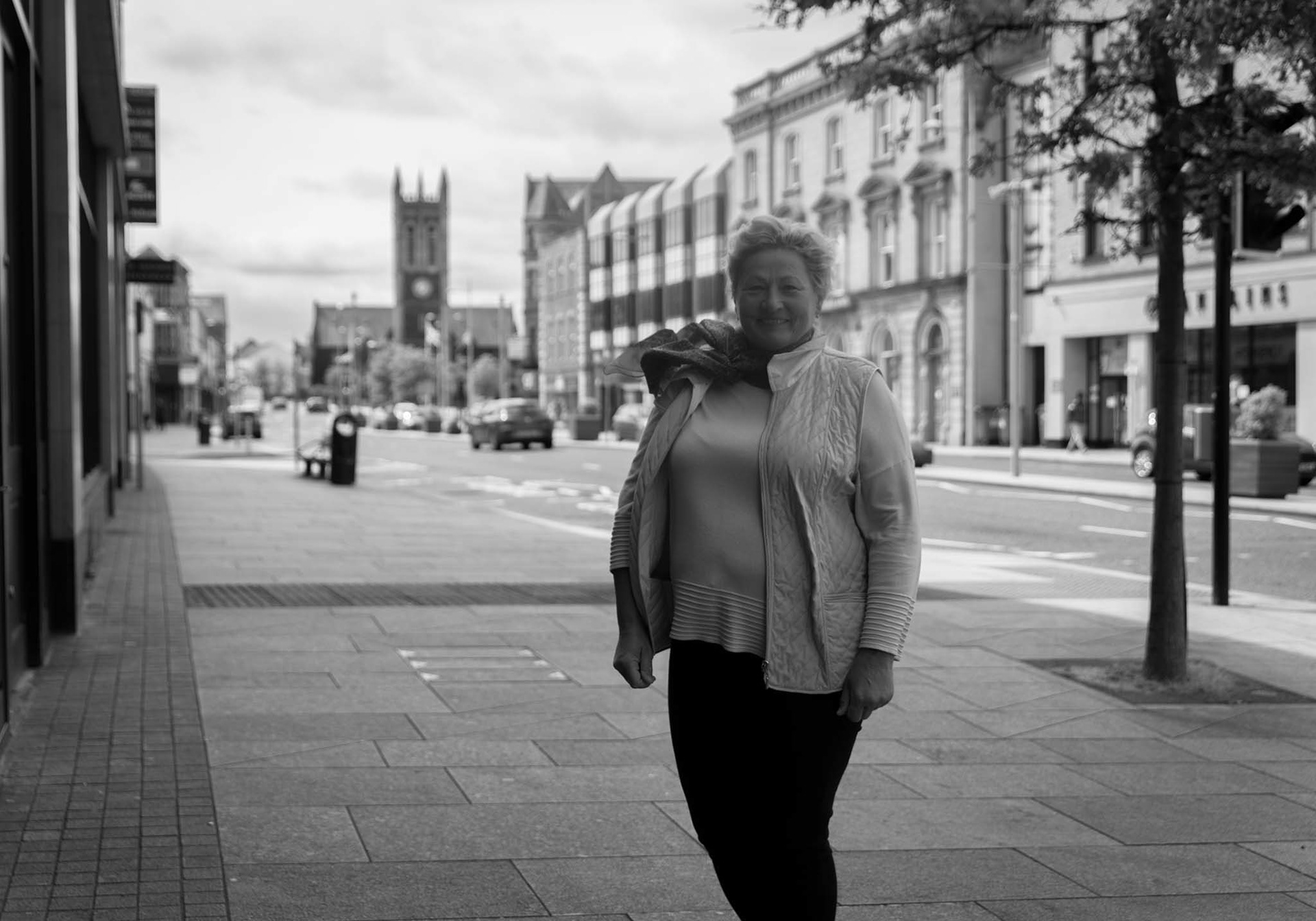 person posing for photo in town centre