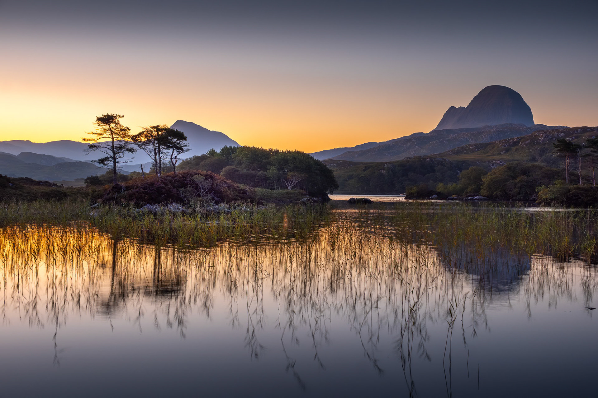 Sunrise at Loch Druim, Assynt, north west Scotland, with the peaks of Canisp and Suilven.