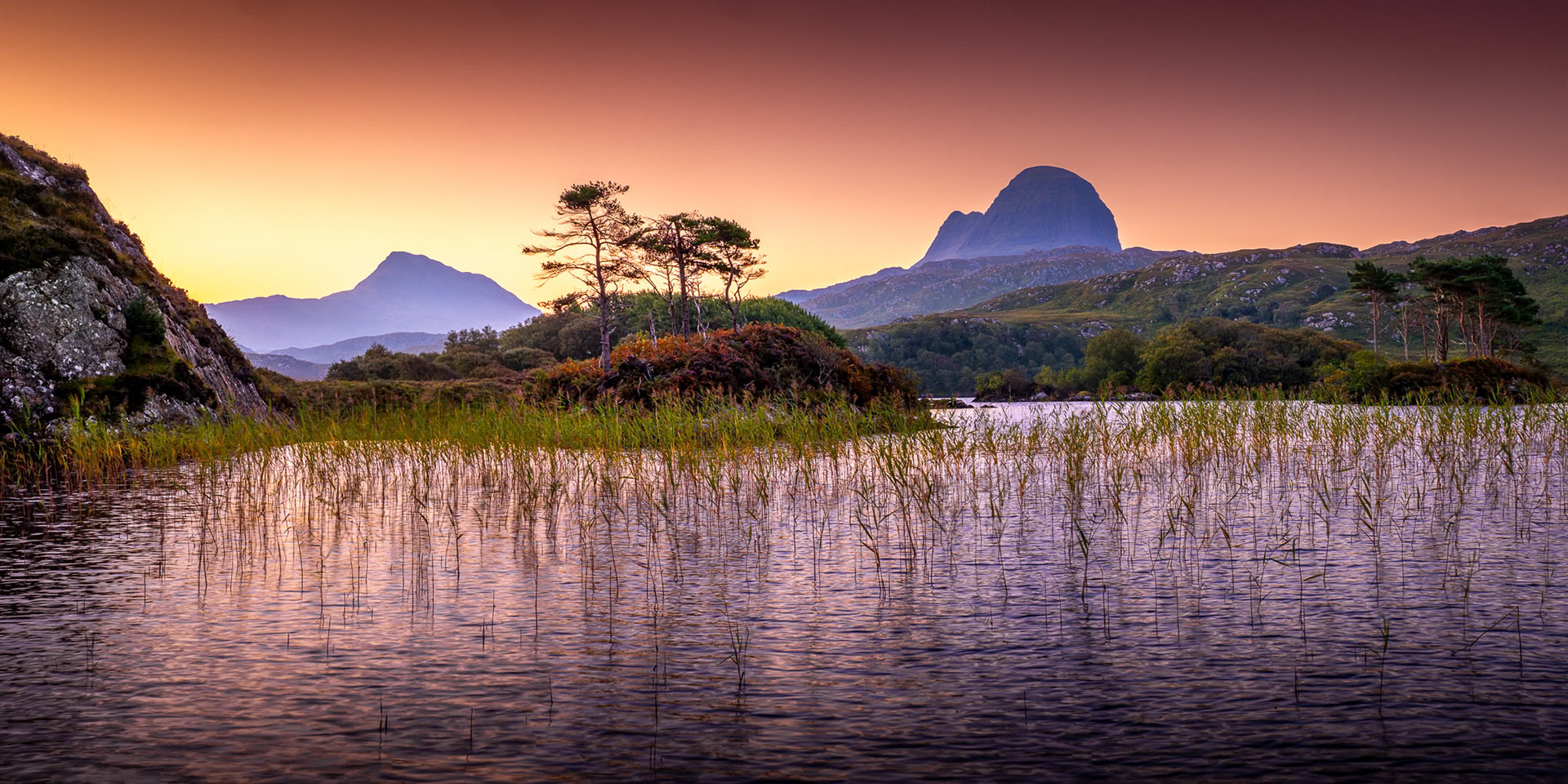 Sunrise at Loch Druim, Assynt, north west Scotland, with the peaks of Canisp and Suilven.