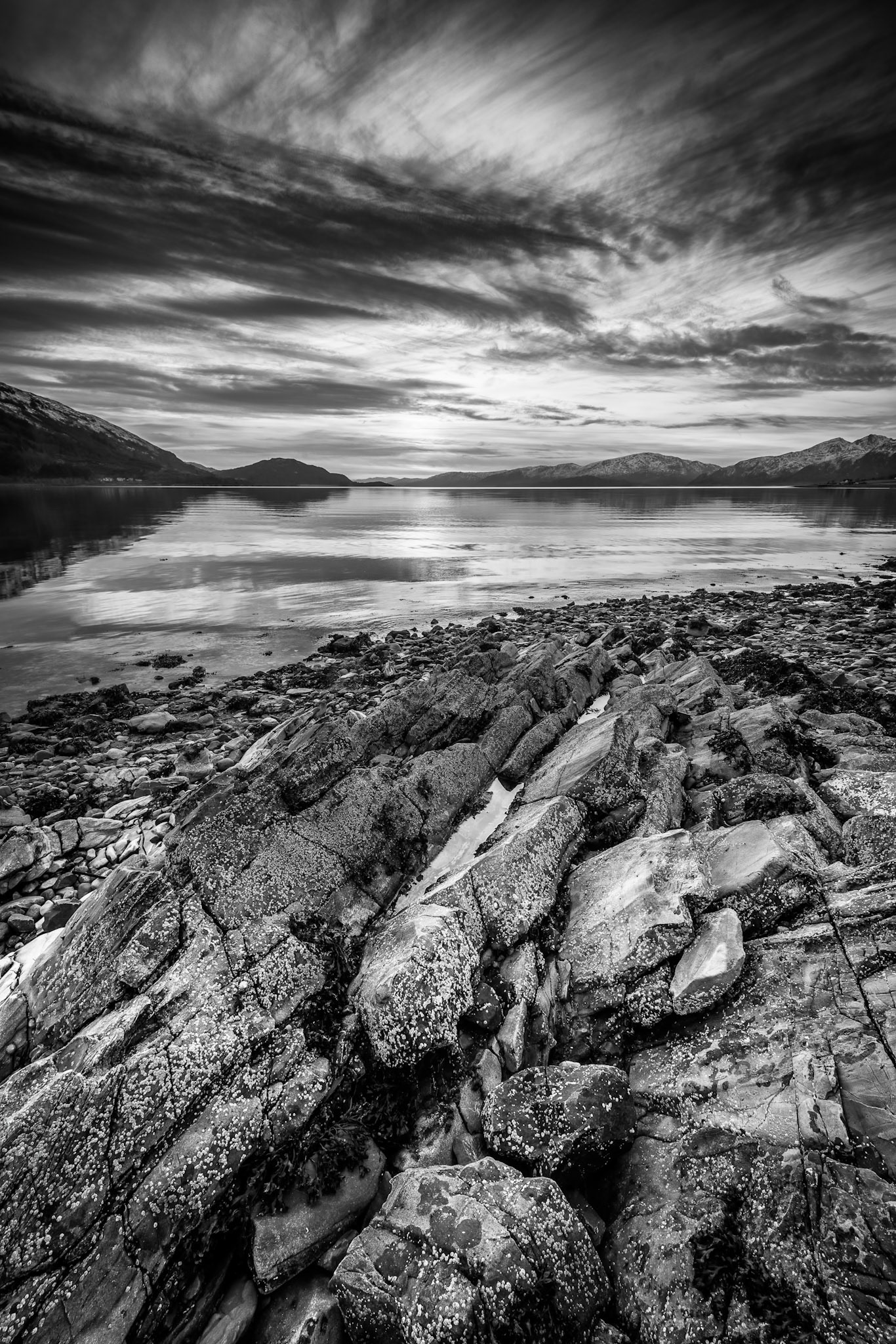 The sun sets over Loch Lochy in the Great Glen, Scotland. Loch Lochy is a large inland freshwater loch which forms part of the Caledonian Canal.