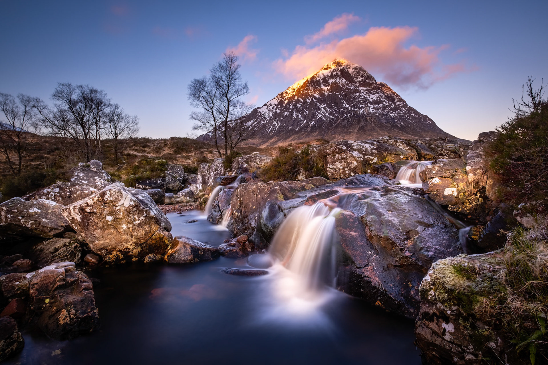 The rising sun catches the peak of Buachaille Etive Mor in Glen Coe, Scotland