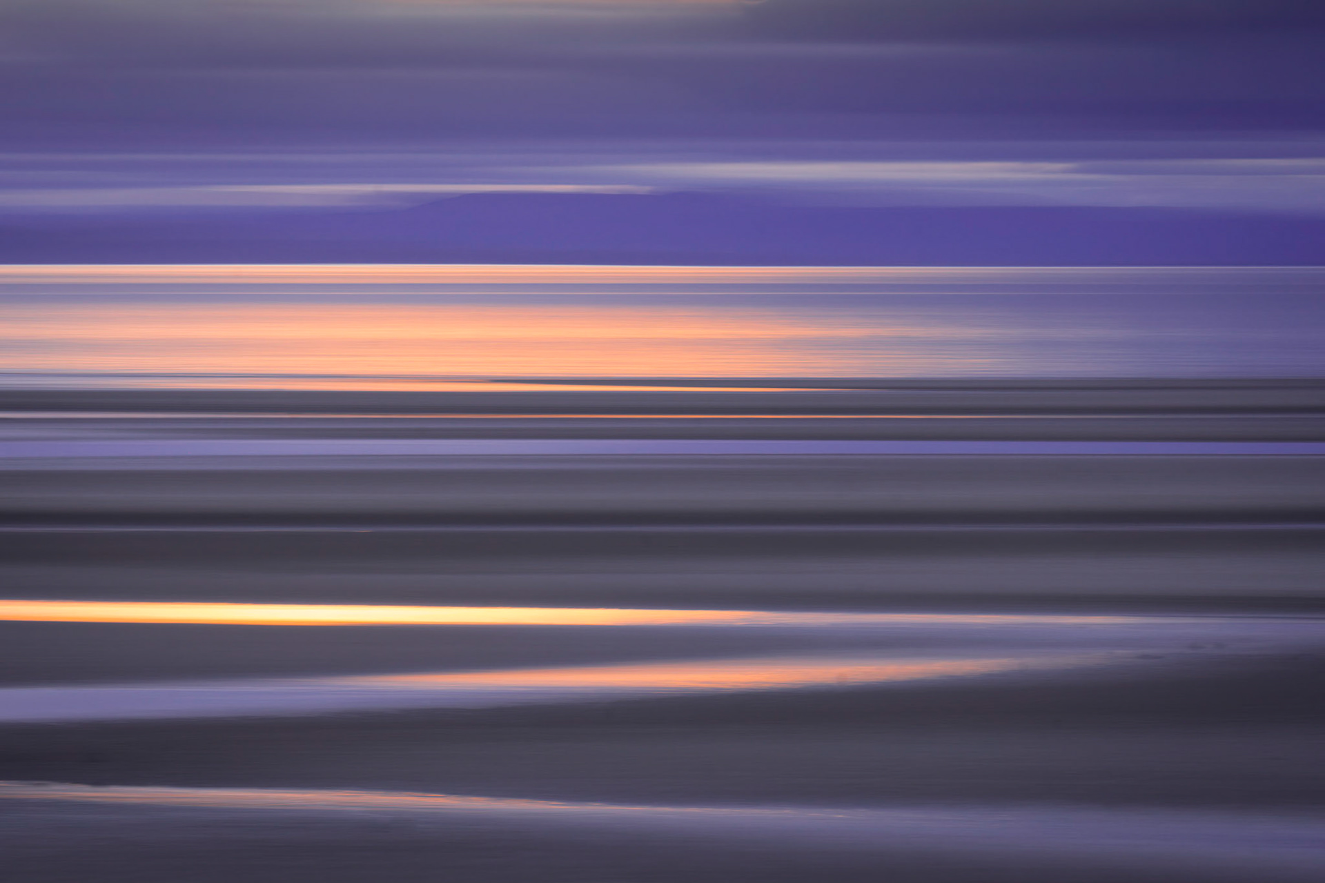 Sunset reflected in the waters of the Moray Firth at Burghead,. Taken with intentional camera movement (icm).