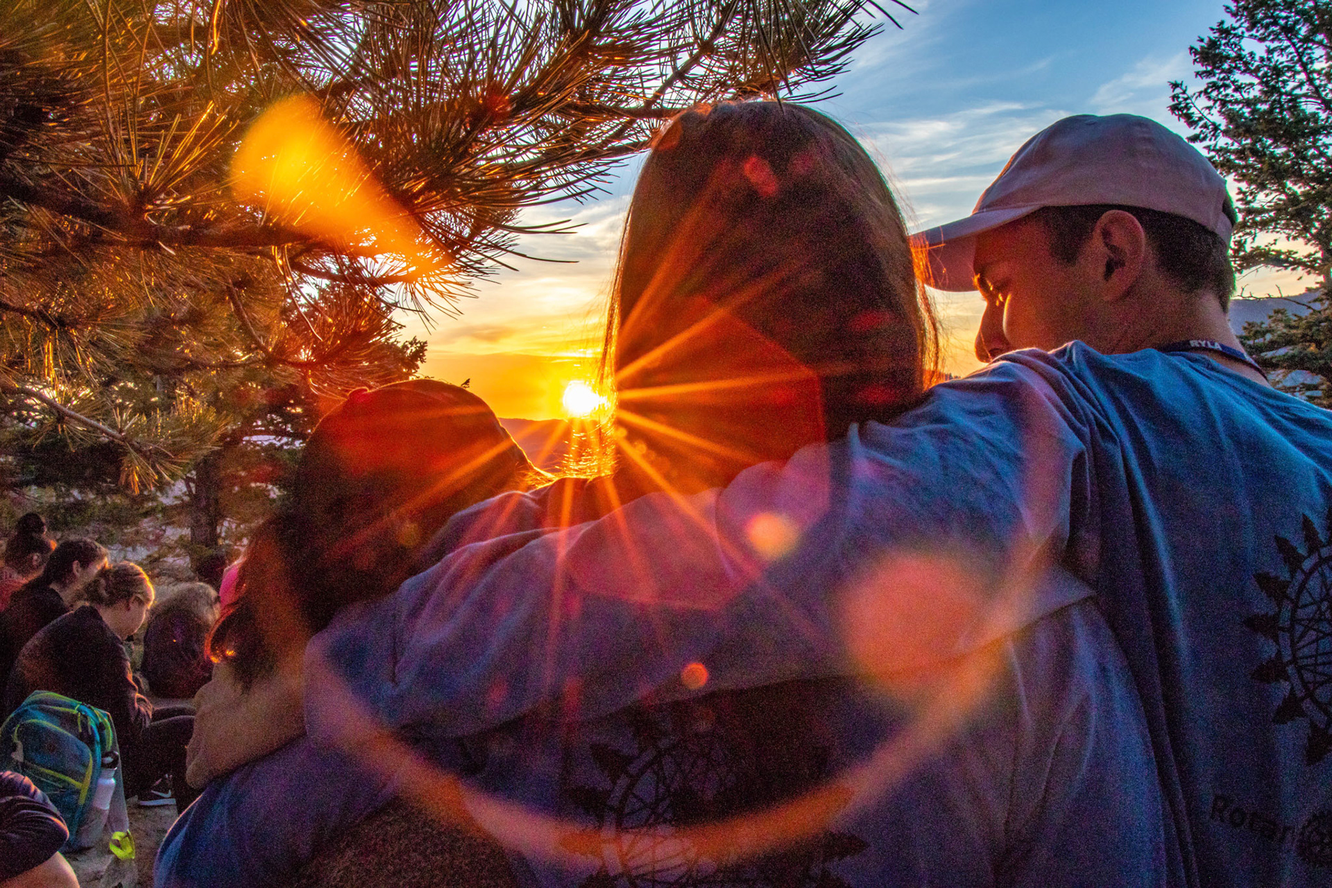Three junior counselors watch the sunrise at the 2018 Rocky Mountain Rotary Youth Leadership Awards in Estes Park, Colo.