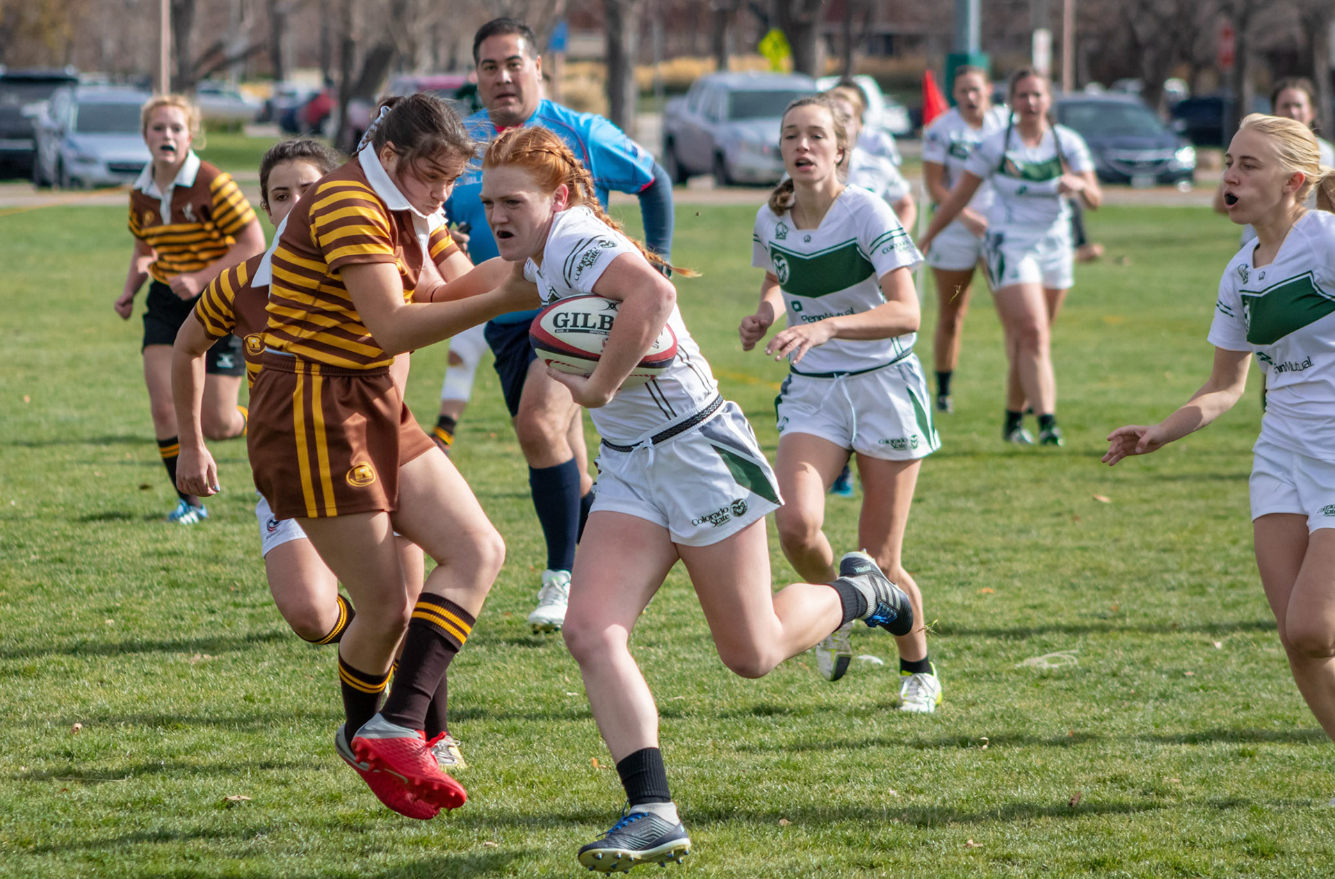 Olivia Martin stiff arming the competition on the way to a 48-27 win for Colorado State Women's Ruby over the University of Wyoming on Nov. 4, 2018.