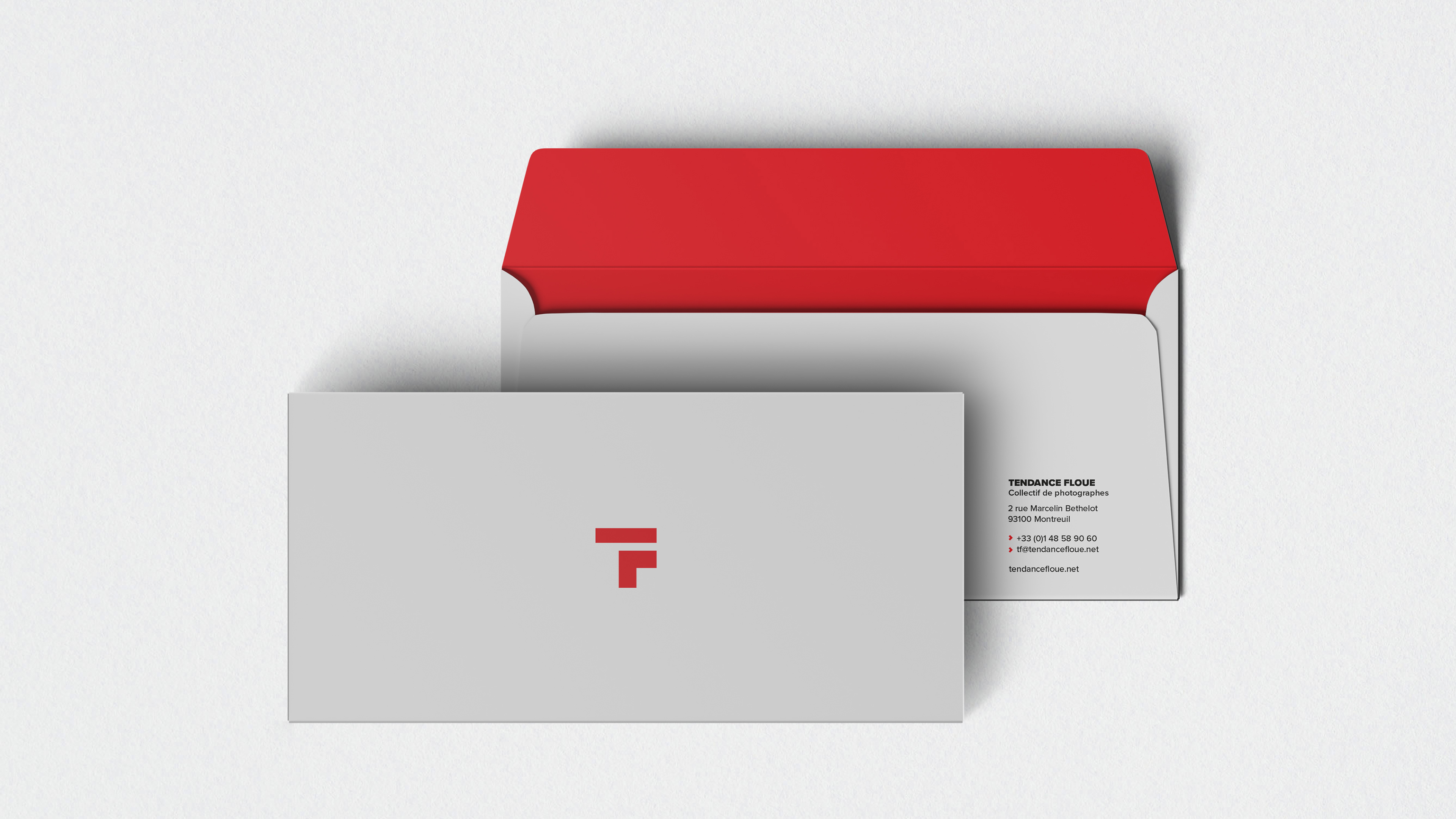 Front and back envelopes with red branding and mailing information