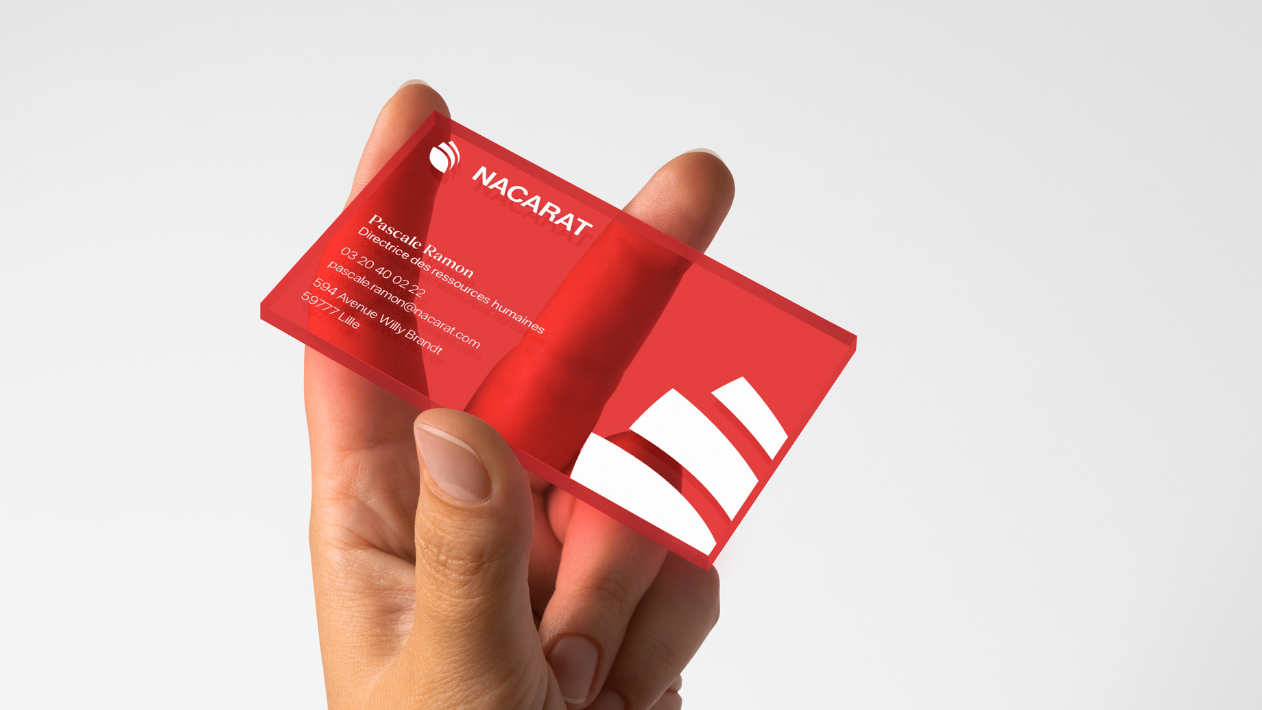 Hand holding a red transparent business card with white infos
