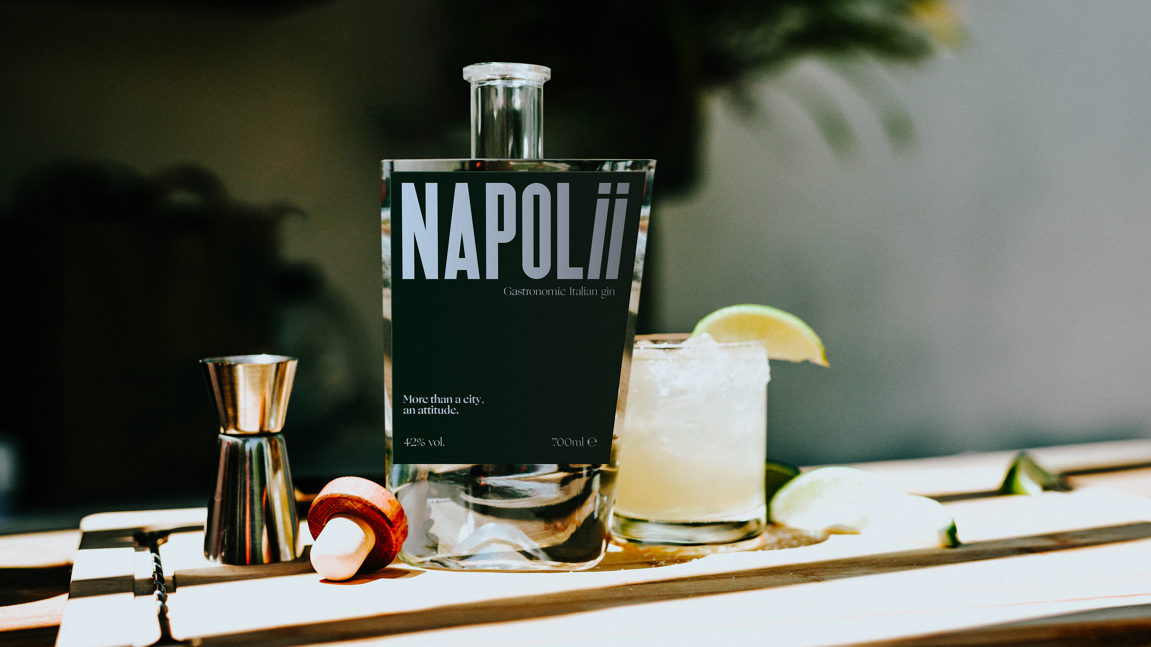 Gin bottle on a counter with a cocktail
