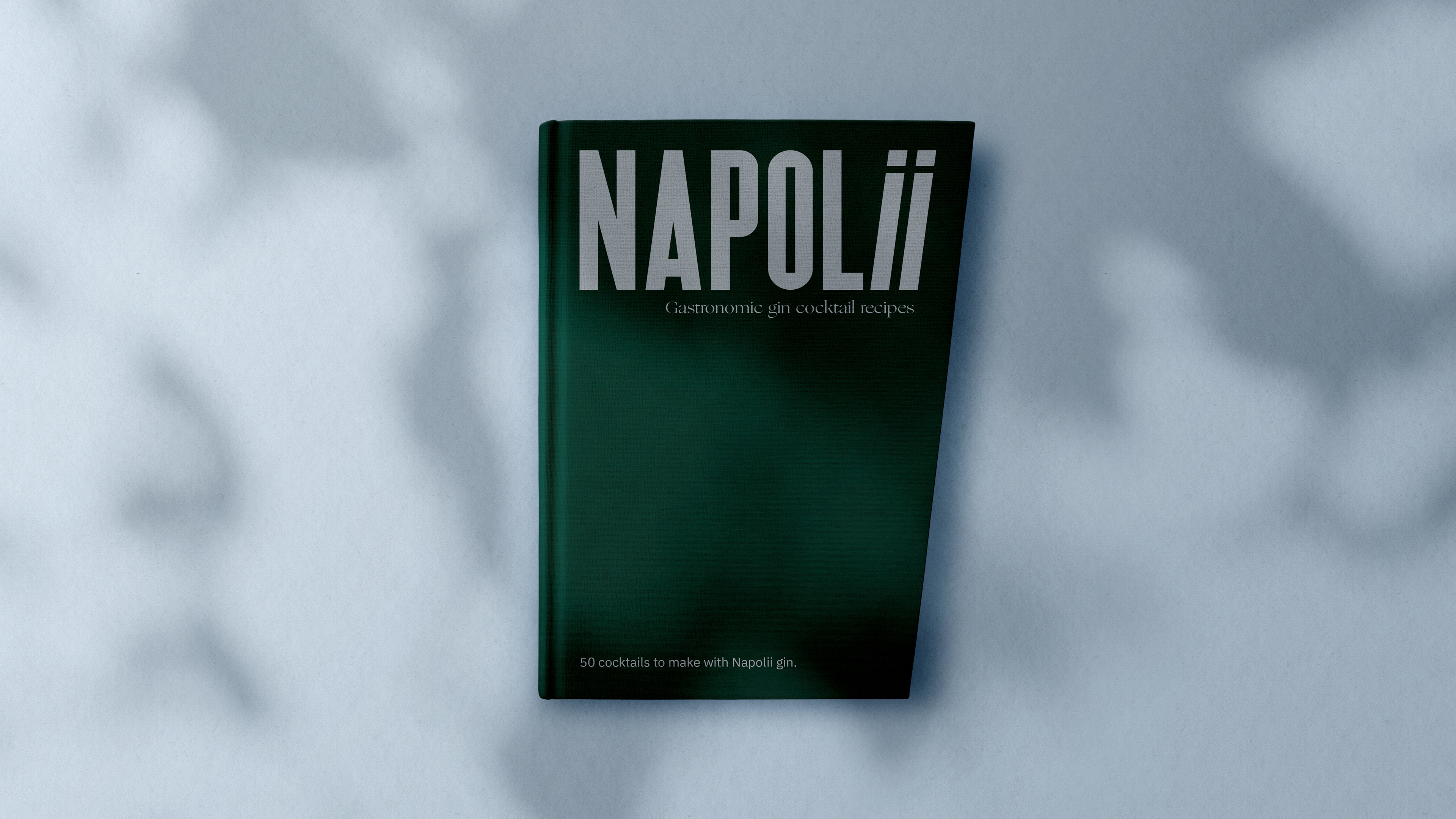 Dark green cocktail book cover on blue background