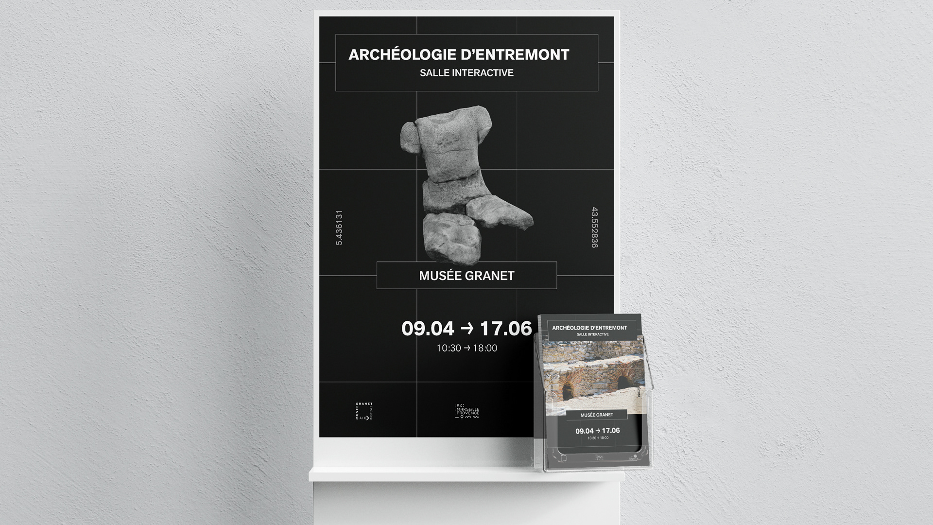 Poster and exhibition booklets on a white display