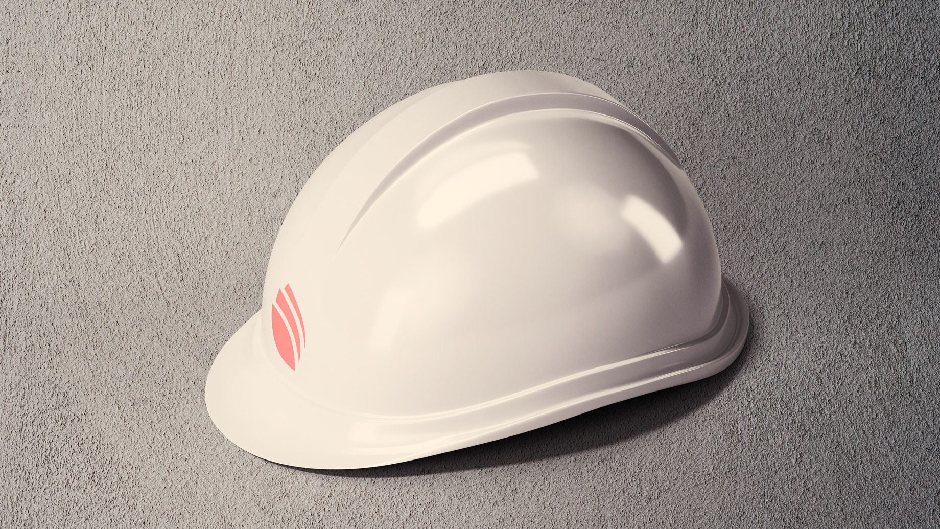 White construction helmet with red brand symbol on concrete