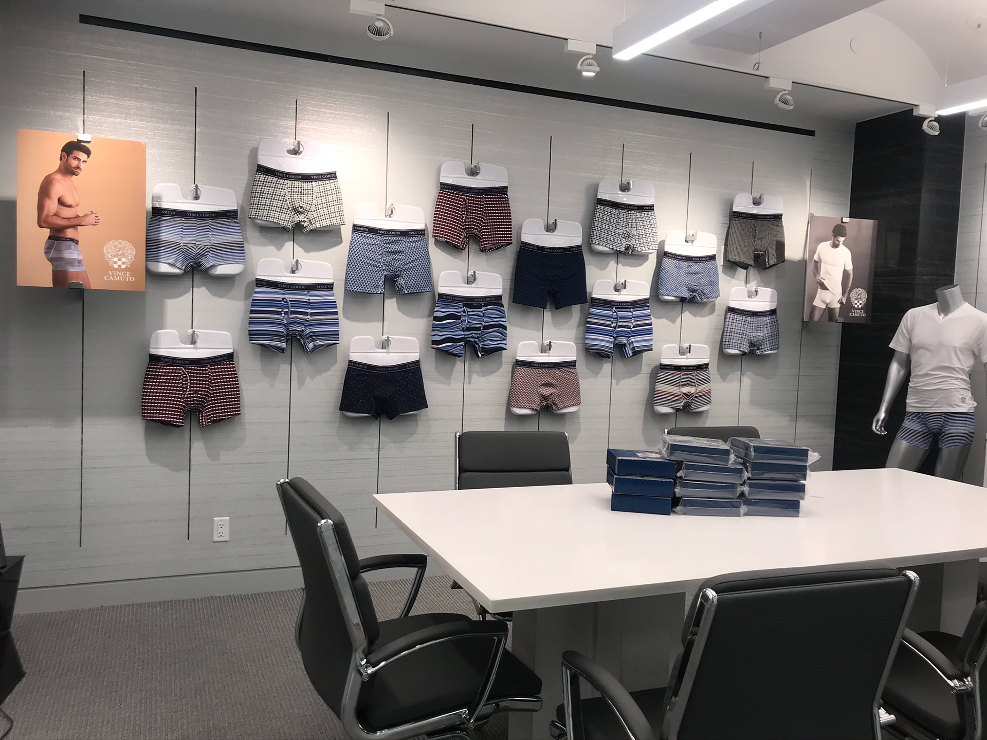  Image of full line of mens underwear hanging on the wall in a conference room