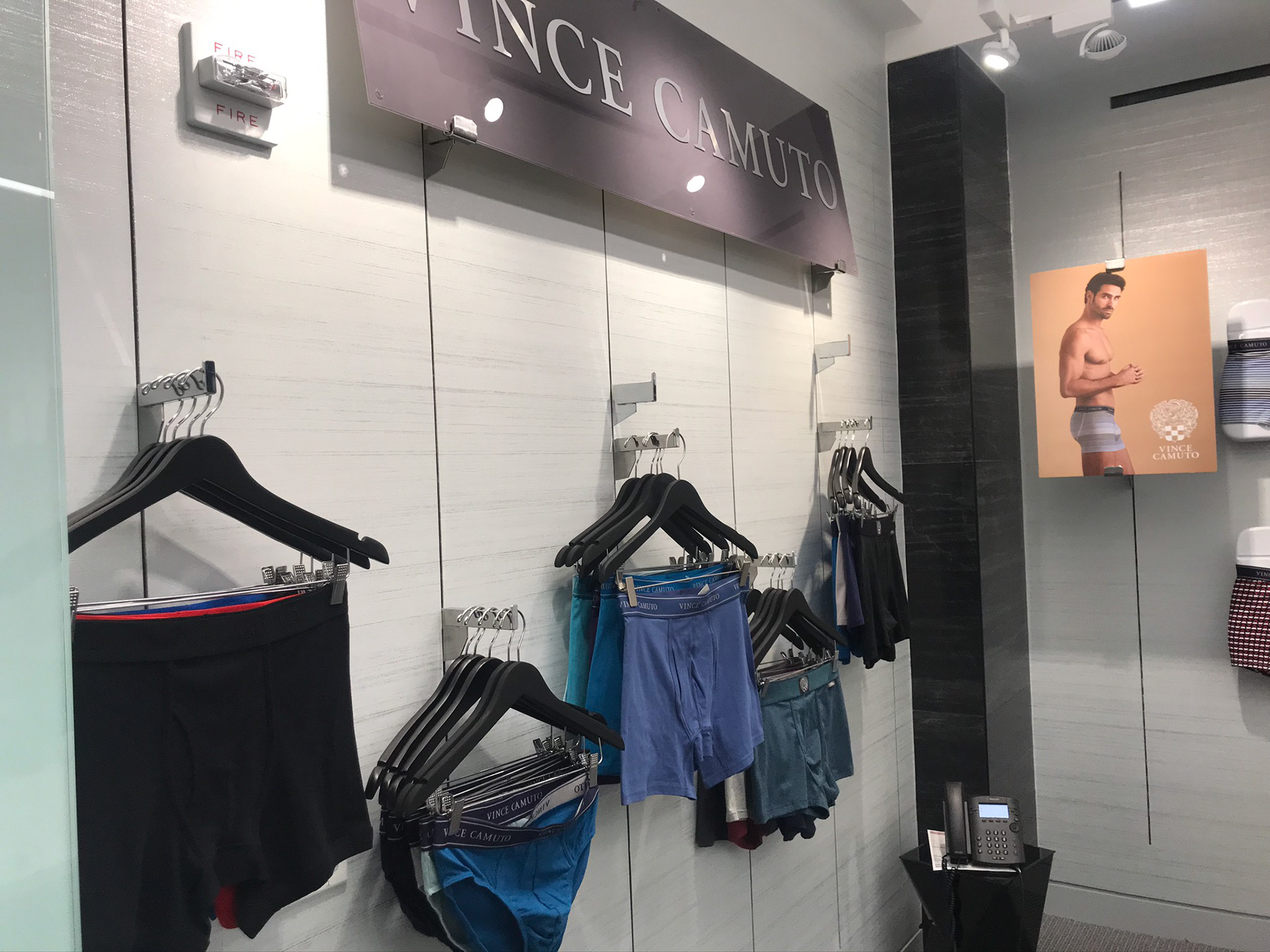  Image of full line of mens underwear hanging on the wall in a conference room, side angle