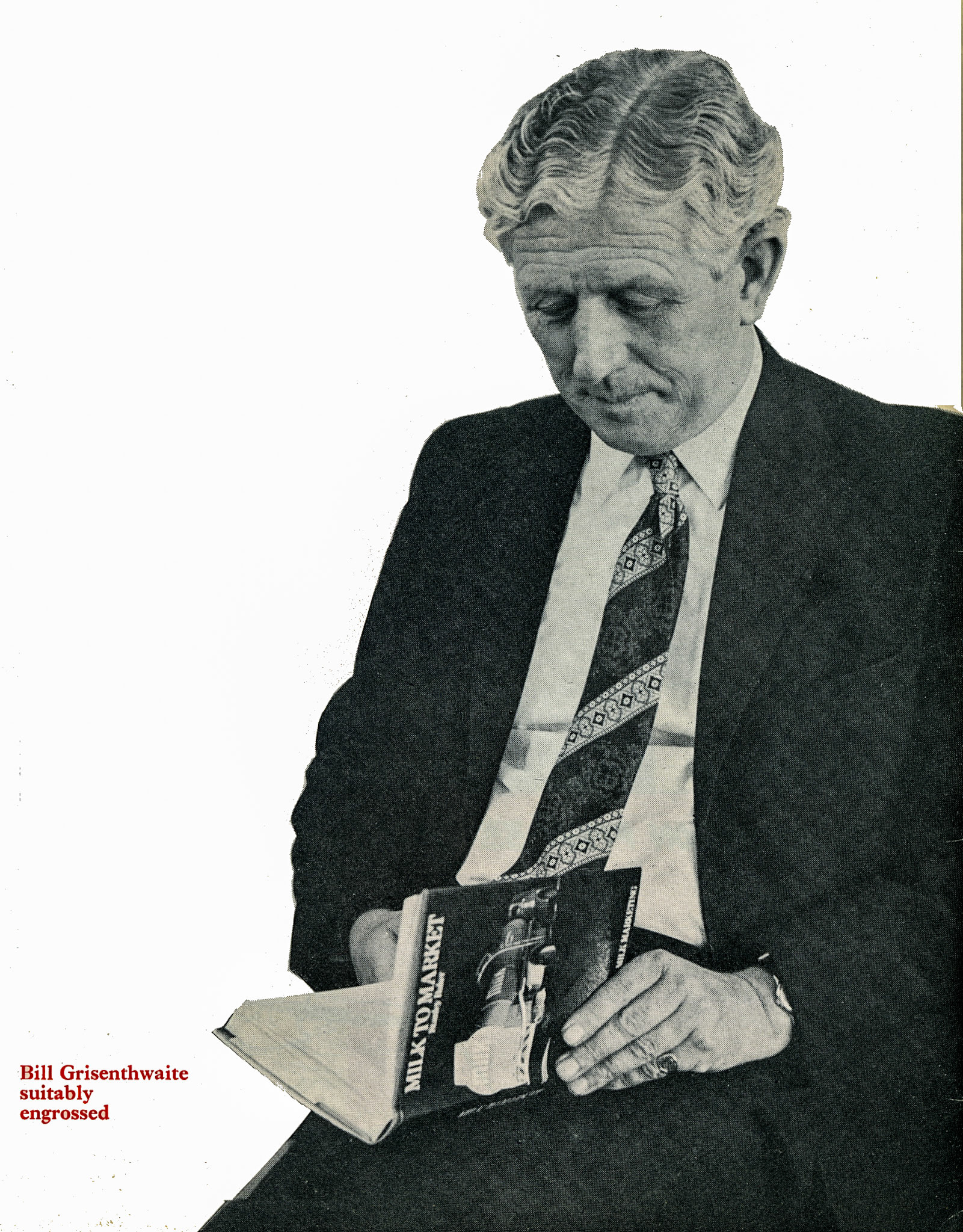 1973 Bill Grisenthwaite, Commercial Director, reads 'Milk to Market' by Stanley Baker
