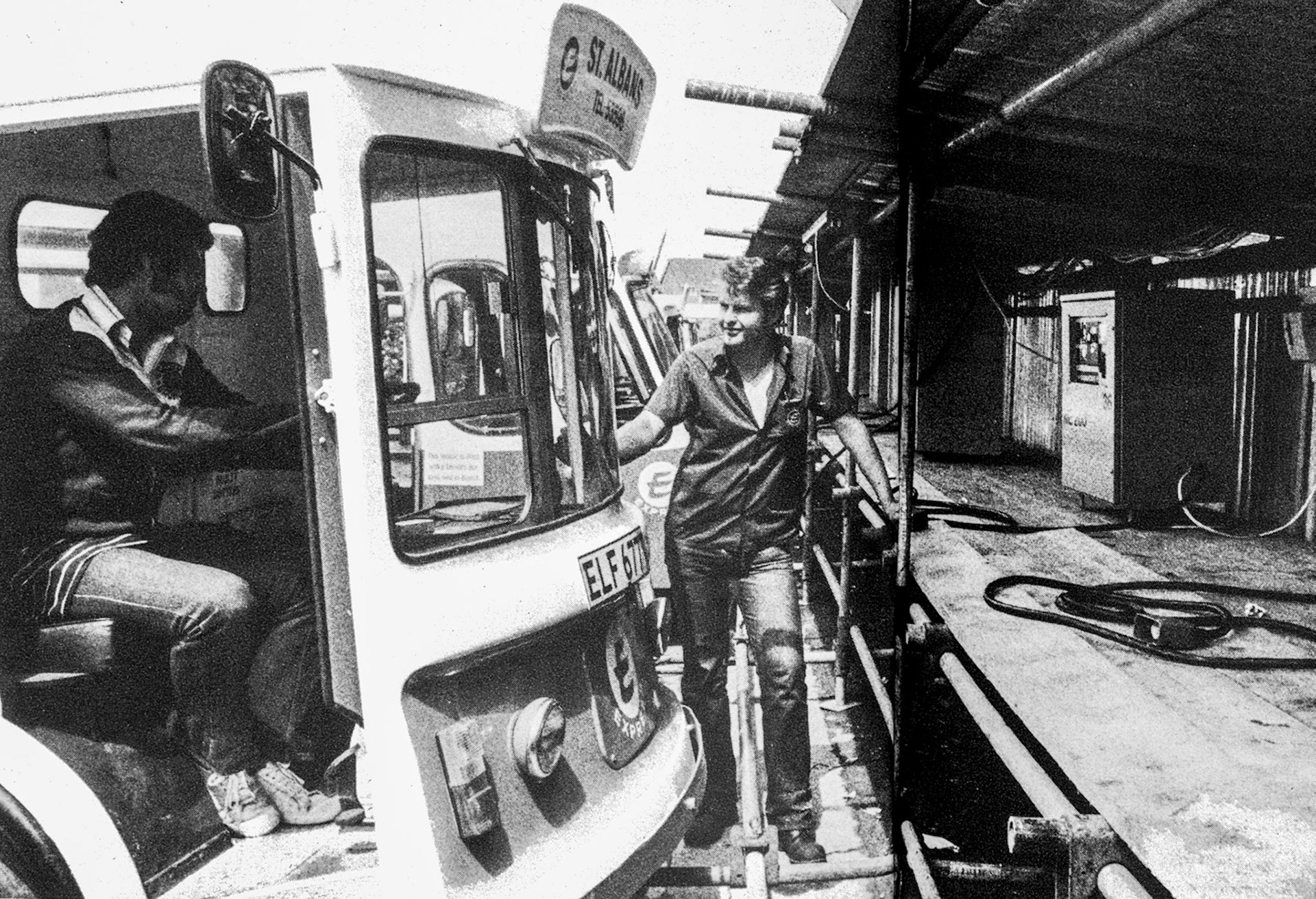 1979 St. Albans Retail fire-"Makeshift shelter for new chargers on the site of the burned out vehicle shed. Roundsman Graham Jeggo brings a float to the temporary shelter, with yardman Martin Allwood." Paul Jeggo comments "My brother Graham Jeggo worked for Express Dairy in Branch Road... convinced it is him, his hair, sideburns and footwear... is just too much of a coincidence, we are only two years apart and spent many years together."(Express News Autumn)