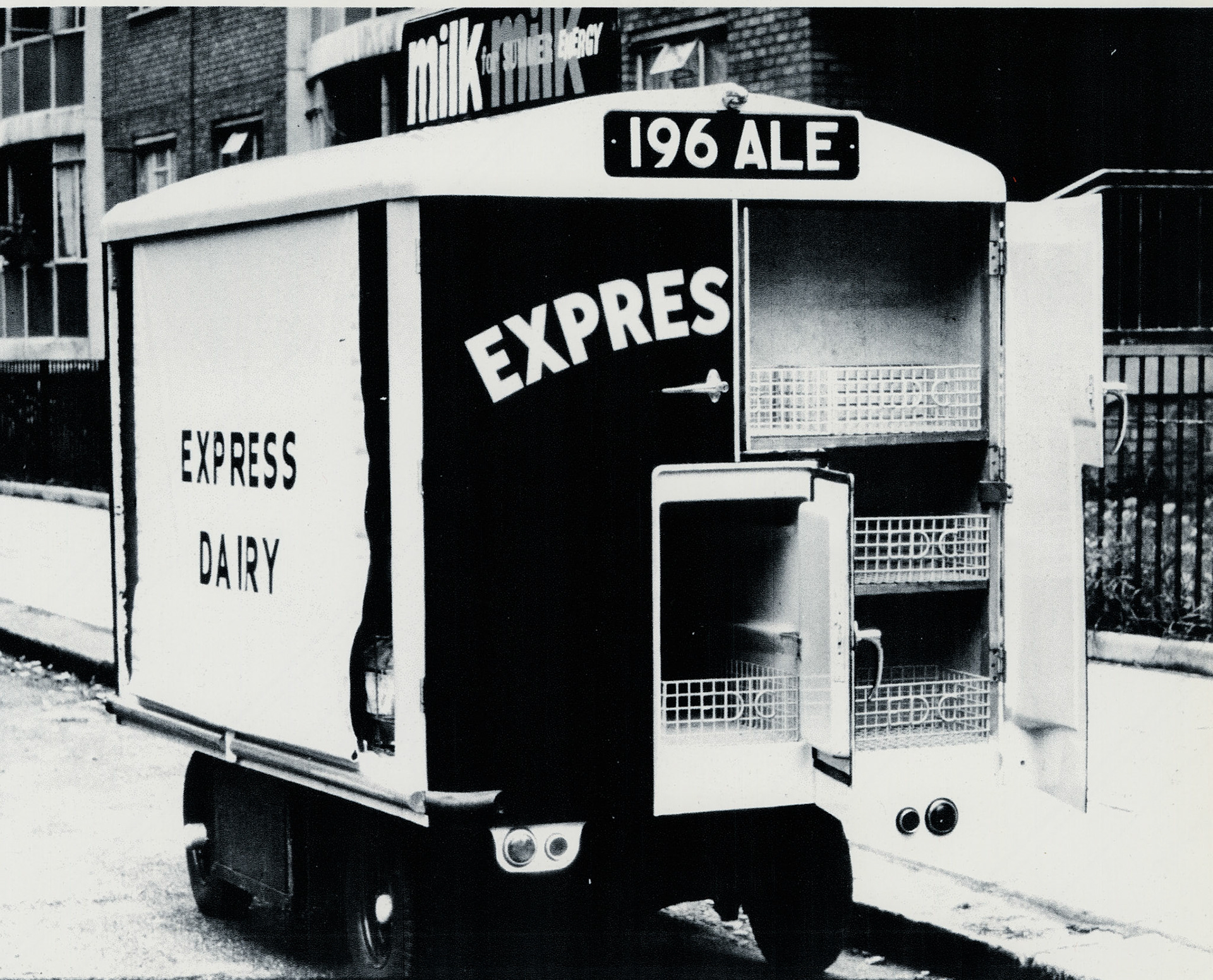 1960 Reg Float with insulated compartments 196 ALE. John Carey comments "We had one in the early 1960s, at Hurlingham Depot, we used to put ice trays (Eutectic Plates) underneath the baskets to keep the products cool. The ice plate cabinets were in all the depots at the time; our refrigeration engineers looked after them, as well as the depot cold stores". Michael Aldread adds " ...filling the ice plate cabines... was one of my last jobs to do before I went home when I was yardman at Canonbury Depot". Paul Batchelor explained "They had two of these floats at North Peckham estate, off Southampton Way Peckham, served by Sydenham depot. I had to weld some security boxes on them for the roundsman collecting their money from the flats, and also had to cage in the float around the milk deck to prevent the milk and goods being stolen. Express pulled out of these estates due to the vandalism caused to the floats". (Courtesy Dave Fane)