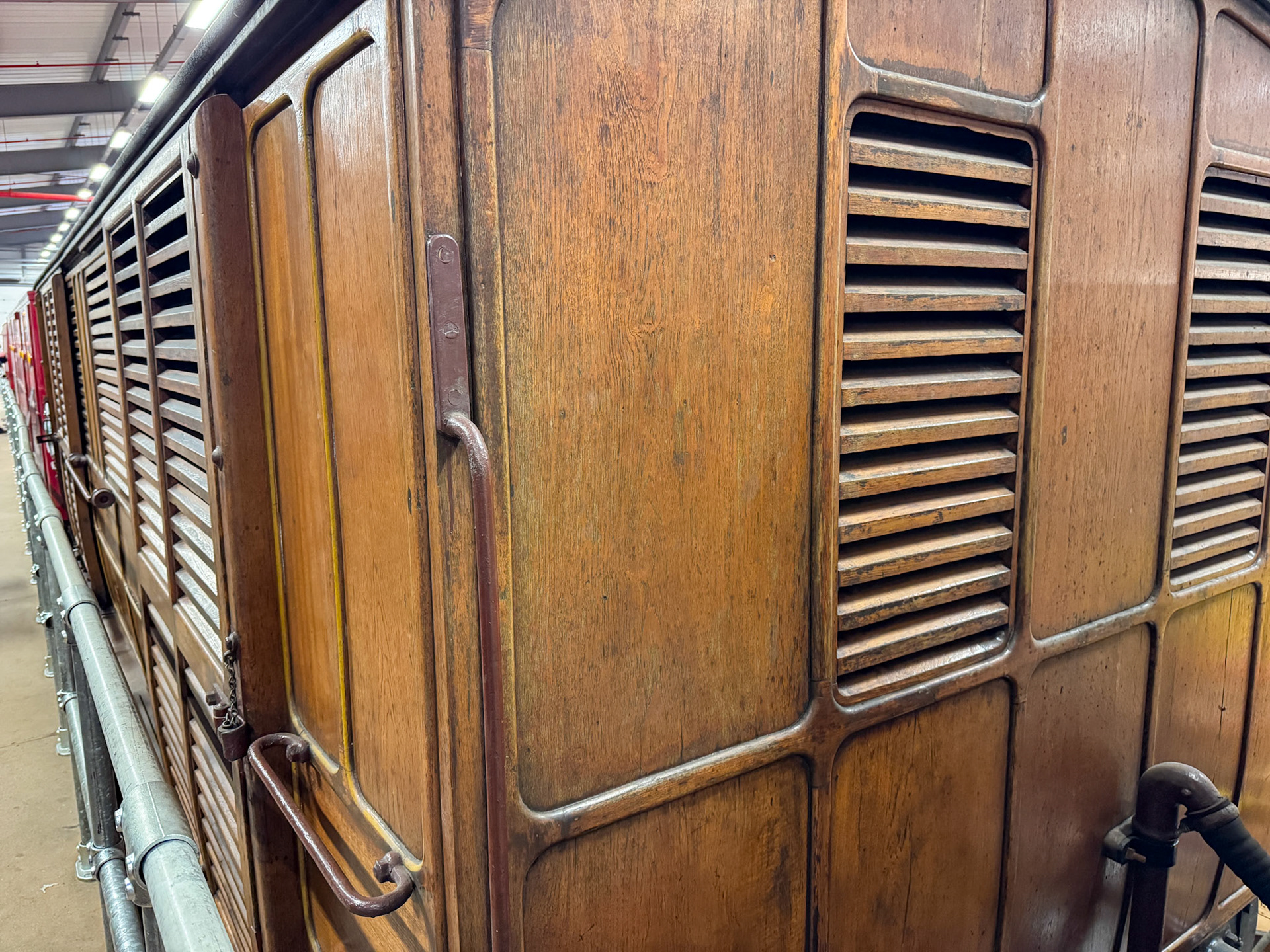 1896 Metropolitan Railway Milk Van No. 3, photographed at the London Transport Museum Depot, Bollo Lane, Acton in April 2025. "This milk van formed part of the steam trains running on the Metropolitan Railway and was used to transport milk into London from farms in Hertfordshire and Buckinghamshire. It sported wood panelling and the hand-painted Metropolitan Railway coat of arms. The car was ventilated to keep the milk fresh and the suspension was modified to prevent it from turning to butter during the journey. The milk van demonstrates the engineering solutions required even for seemingly simple tasks." Accession: 1981/540. Express Dairy Tales collection.