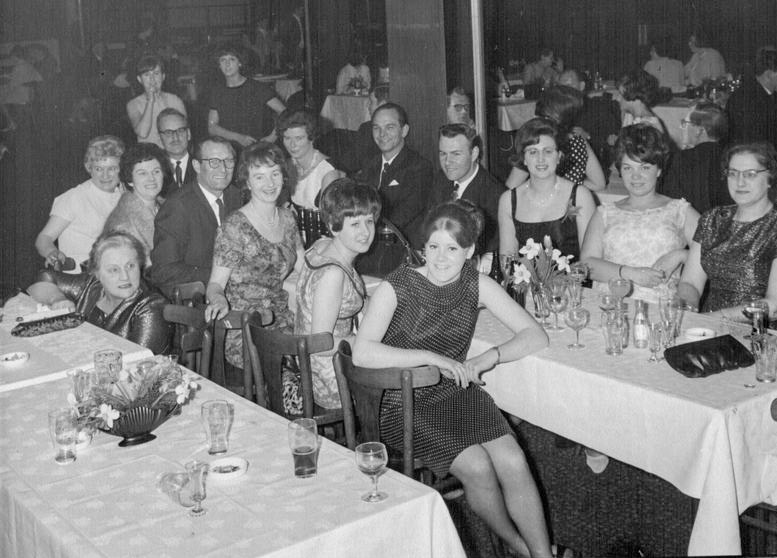 1966 Maidstone Dairy dinner-dance at the Star Hotel Maidstone. Lyn Taylor comments "We all worked at Wickens Dairy, Tonbridge Road Branch, with George Wickens. He was a racing driver, his sister was Lilly Baker who was our Manageress. From the right: Mary Ashby, Val Tree, Gwen Wood, Jean Perkins, standing is Sue Thompson, Jeanie Cook, Joan Drake, Florence Lawrence, Betty Crittenden, myself &amp; Pat Marlowe, Don's daughter. The gentlemen are the husbands sitting with their wives. The Lady crouched down is Mrs Plumbly, a wife of one of the milkmen. Pat Marlowe went on to marry Mike Hodges (trainee manager &amp; son of Jim Hodges, Express Director). Val Tree went on to marry Chris Hare who drove the milk lorries, I went on to marry Bob Taylor, he was a milkman at Romney Place branch. (Courtesy Lyn Taylor)