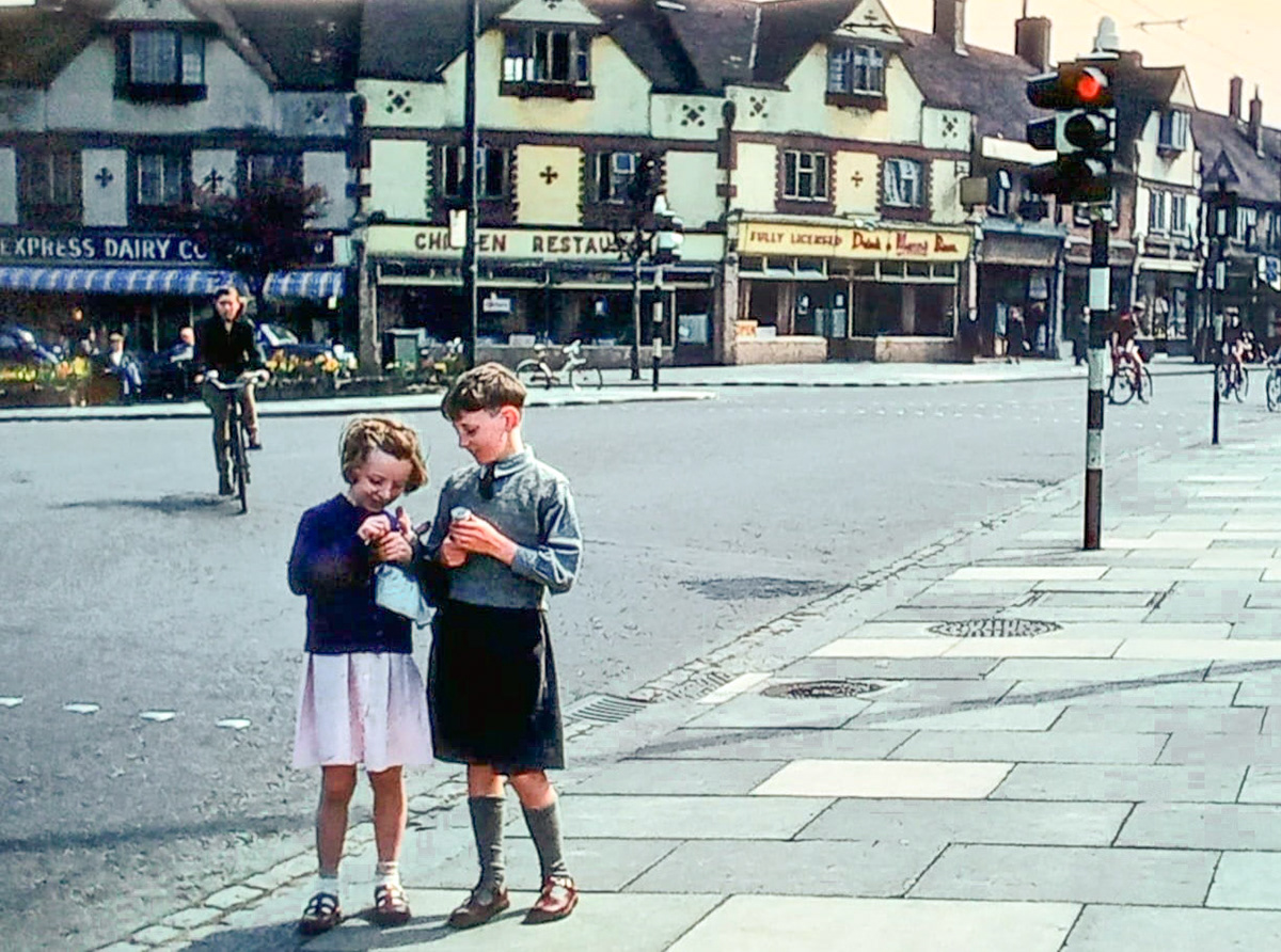1957 Barnet Shop. Tony Cairns comments "My sister Lynda and myself waiting to go into the Odeon on a Saturday, at the top of Station Road. Note the Express Dairy and Chicken Restaurant in the parade of shops." Brian Wastell adds "My aunt Min Oakley was the manager of this shop." Paul Smith also added "My Auntie Barbara was manager of the shop in East Barnet Road, my mum also worked there and often went up to the shop pictured to help out." (Courtesy Tony Cairns)