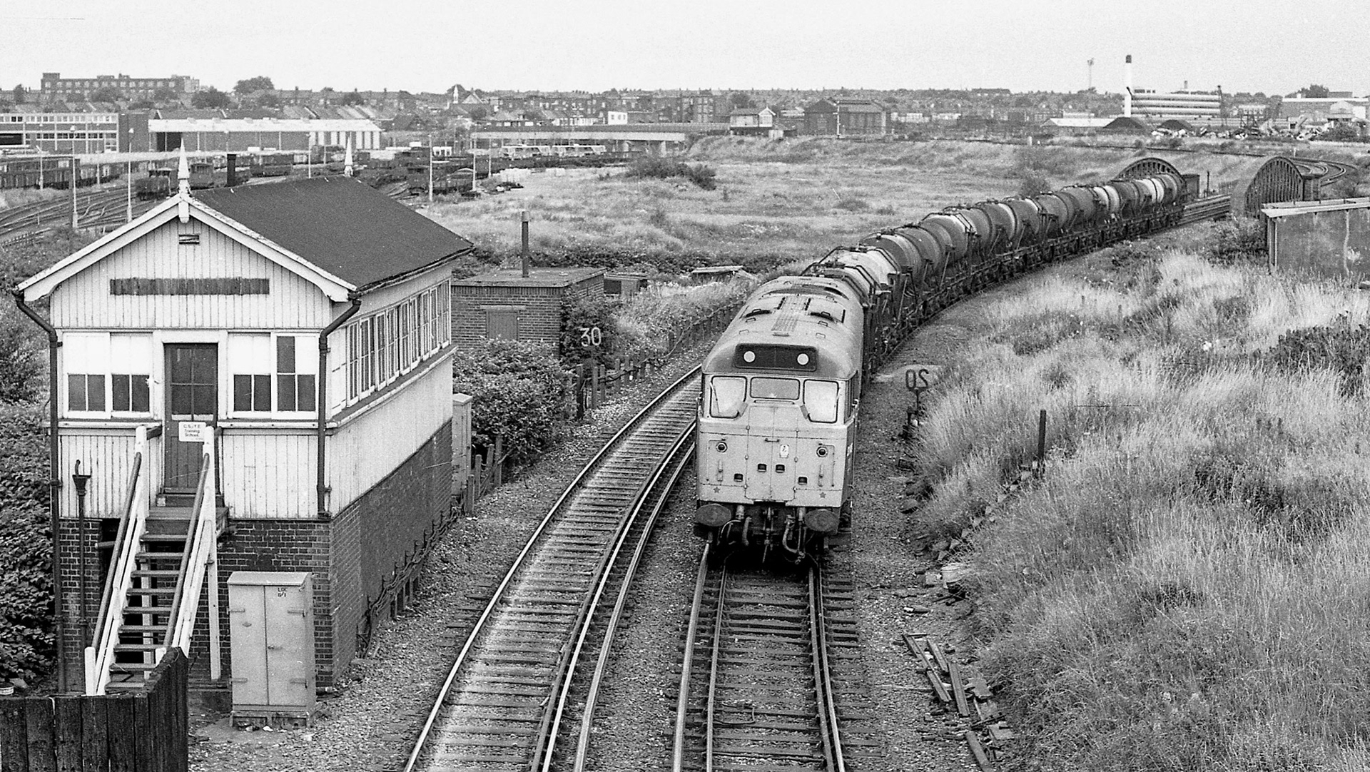 1979, Old Oak Junction. 31148 caught passing the closed signal box at Old Oak Junction on 19 July. Likely to be empties from Express Dairy Cricklewood, returning to the West Country. (Courtesy Kevin Lane)