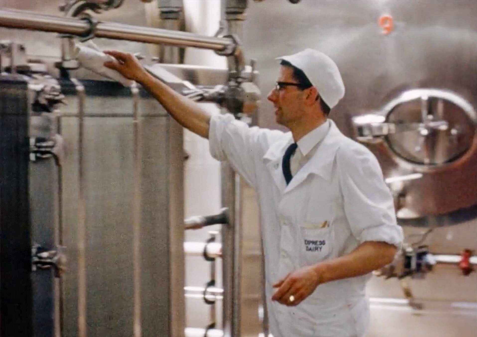 1954 South Morden Processing-preparing for filter change. Twin filters were incorporated into the plate heat exchanger body; later separate external filters were used. (Stills from Express Dairy Film)