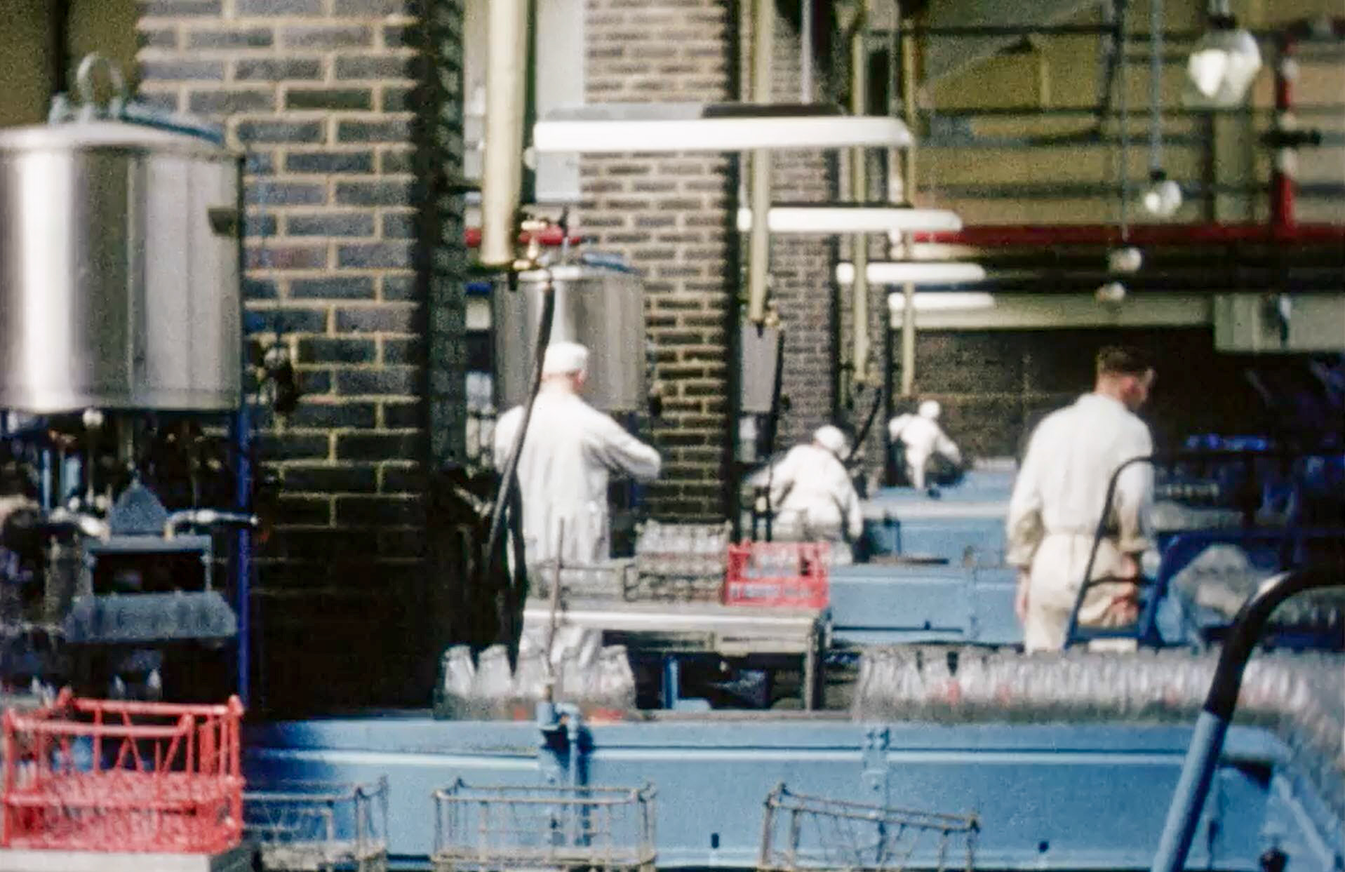 1954 South Morden Processing-decrating. The red crates were for bottles that were too dirty or damaged to re-use. (Stills from Express Dairy Film)