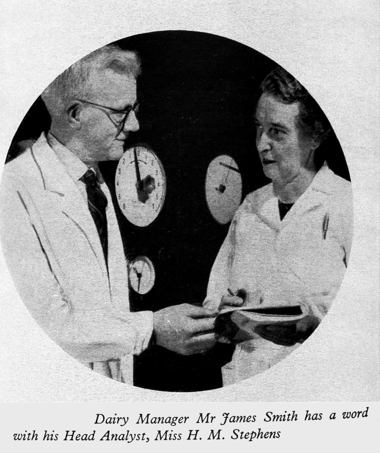 1961 Millroad Street, Glasgow bottling plant. Dairy Manager James Smith talks to Miss H.M. Stephens, Head Analyst. (Express News Autumn)