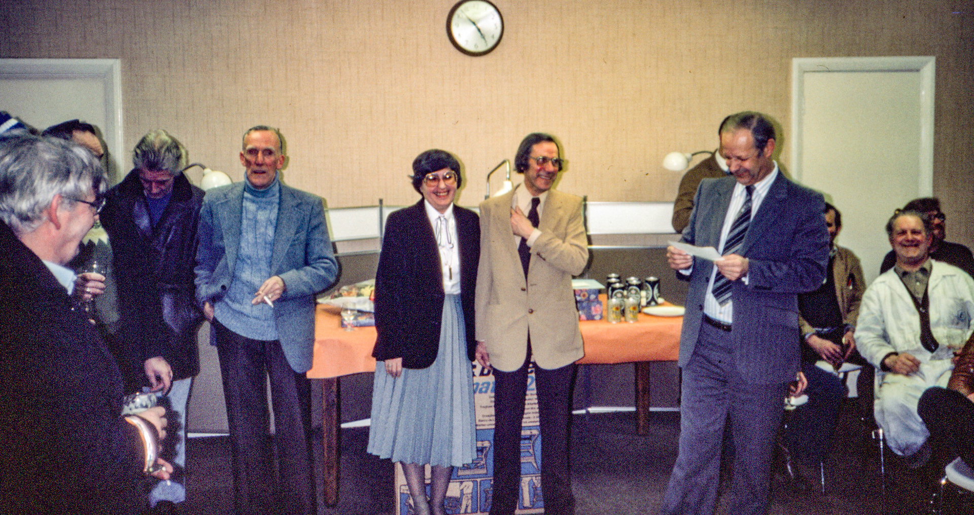 1981 South Morden visitors room. Retirement party for George Parker. L-R Mr Tobin, ?, ?, ?, Mrs Parker, George Parker, Derek Gray, Johnny Fargher in the white overalls.