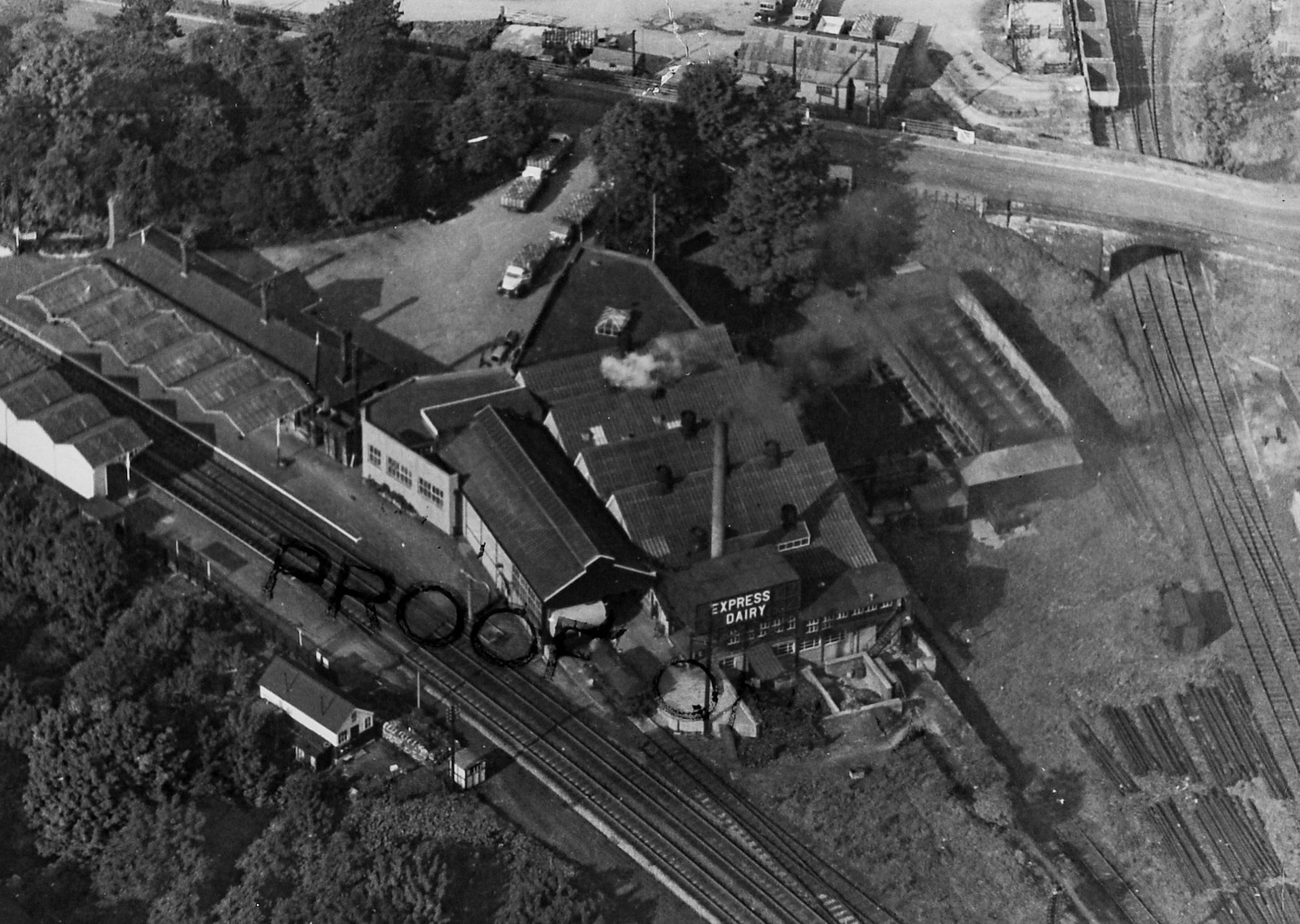 1950's Rowsley Dairy aerial view, showing adjacent station and dairy rail sidings. Timothy Collier comments "The lines on the right went into the original station (in those days a terminus) at the time of this photo a goods yard." (Courtesy Derbyshire Record Office, donated in March 1985; they had previously belonged to the donor's father, who was an electrical engineer with the dairy.)