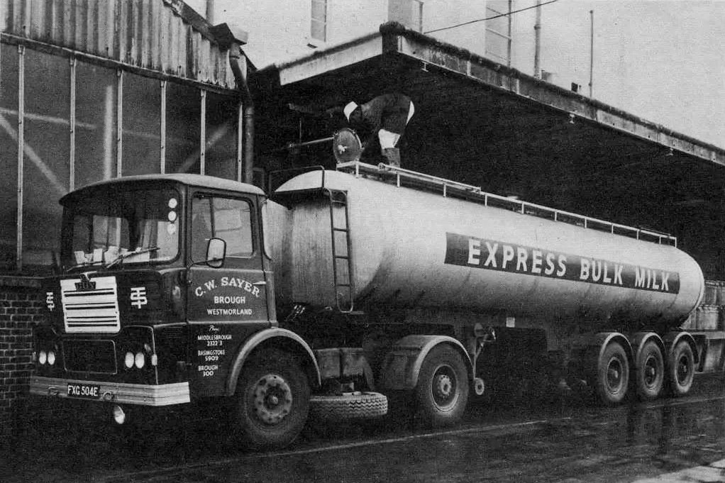 1960's Tanker, 1967 Reg C.W. Sayer tractor, at Appleby. Chris Ewart comments "Could be Express Dairy Appleby-looks like it when I used to load milk tankers with Ernie Hind?" David Atkinson adds "Think that looks like Jack Turnbull on top of the tank so therefore it will be Appleby!". Fiona Egglestone confirms. The caption on the article reads "This vehicle is a typical example of the general bulk liquid carrier's need for the biggest possible payload. It carries 5,000gal of milk in three compartments (two of 2,250gal and one of 500gal) and is constructed from EN58B quality stainless steel. The running gear is a Northern Trailer Co. Ltd. three-axle type incorporating a Ceschi rearmost steering axle." (Courtesy Thelonious Monk)