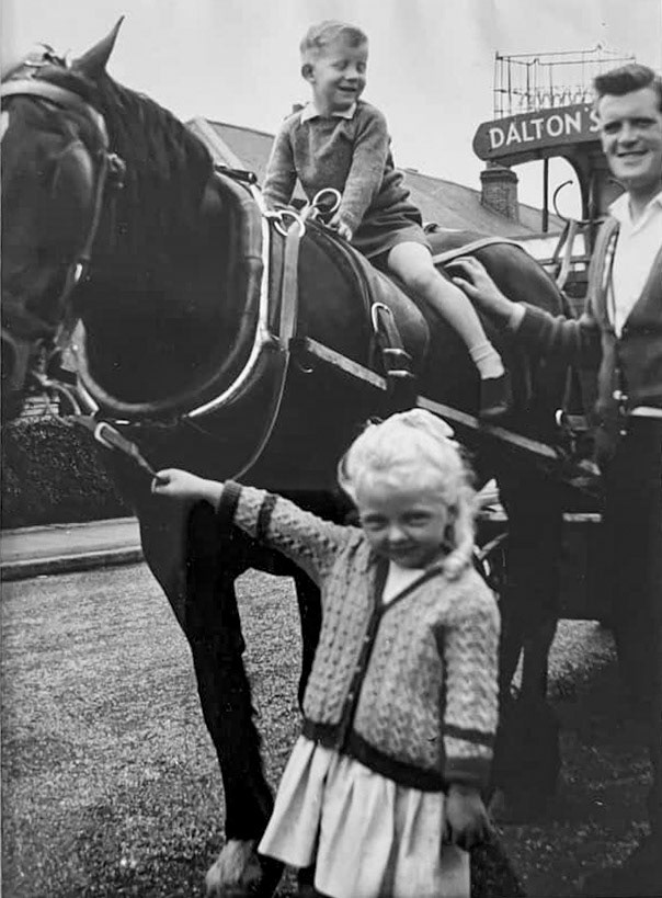 1961 Dalton's Dairies delivery in Westbourne Road, Hillingdon, Julie remembers "This is me with my friend Christopher, we loved having a ride on the milk cart. My 93 year old Mum took the photo, the horse would always stop outside our house and wouldn’t move again until she was given a carrot!! We had 6 pints of milk a day delivered!! 😊😊Happy days!! Ian Torbet adds "the milkman was Gordon, and the horse was called Queenie". (Courtesy Julie Hunt, London Borough Hillingdon Past in Pictures FB Group)