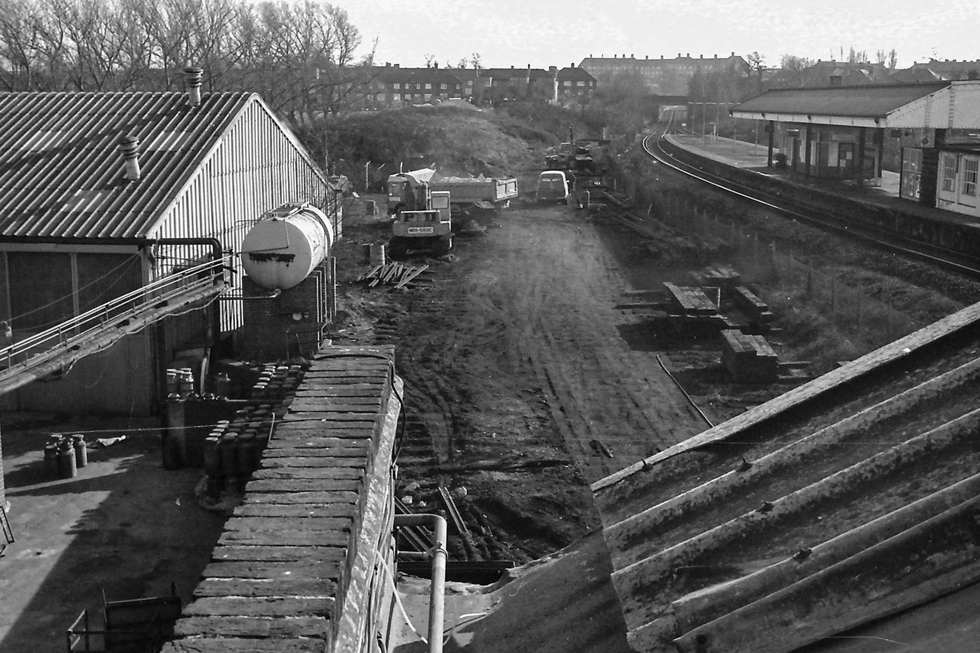 1979 South Morden rail siding and track removal. Raffaele Ralph Phillips comments "Our workshop for garage maintenance on the left, which at one time housed a trailer washing facility, a painting facility along with a tyre department for storing tyres and a tyre cutting machine/ compressor for servicing and repairs on tyres. One section of the garage was for fork lift maintenance and repairs, done by Phil Plumpton who was attached to the E V M department. When l started my apprenticeship in 1970 the garage was part of T H Lewis motor engineers and they rented the site from Express Dairy, so was never a part of the actual dairy!!" (Photographer Sam Jones)