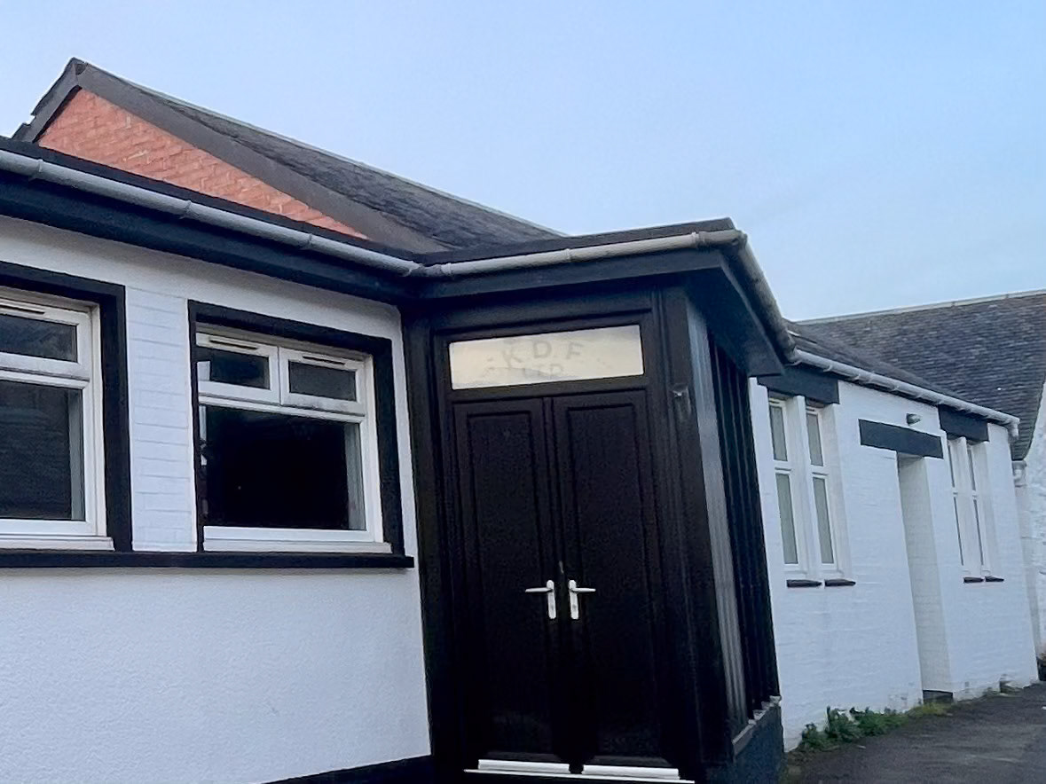 2026 Kilmaurs Creamery buildings in use as part of a storage area, originally believed to be the laboratory. Glass window above double doors is original Kilmours Dairy Farmers Ltd sign KDF Ltd. (Courtesy Fiona Edgar)