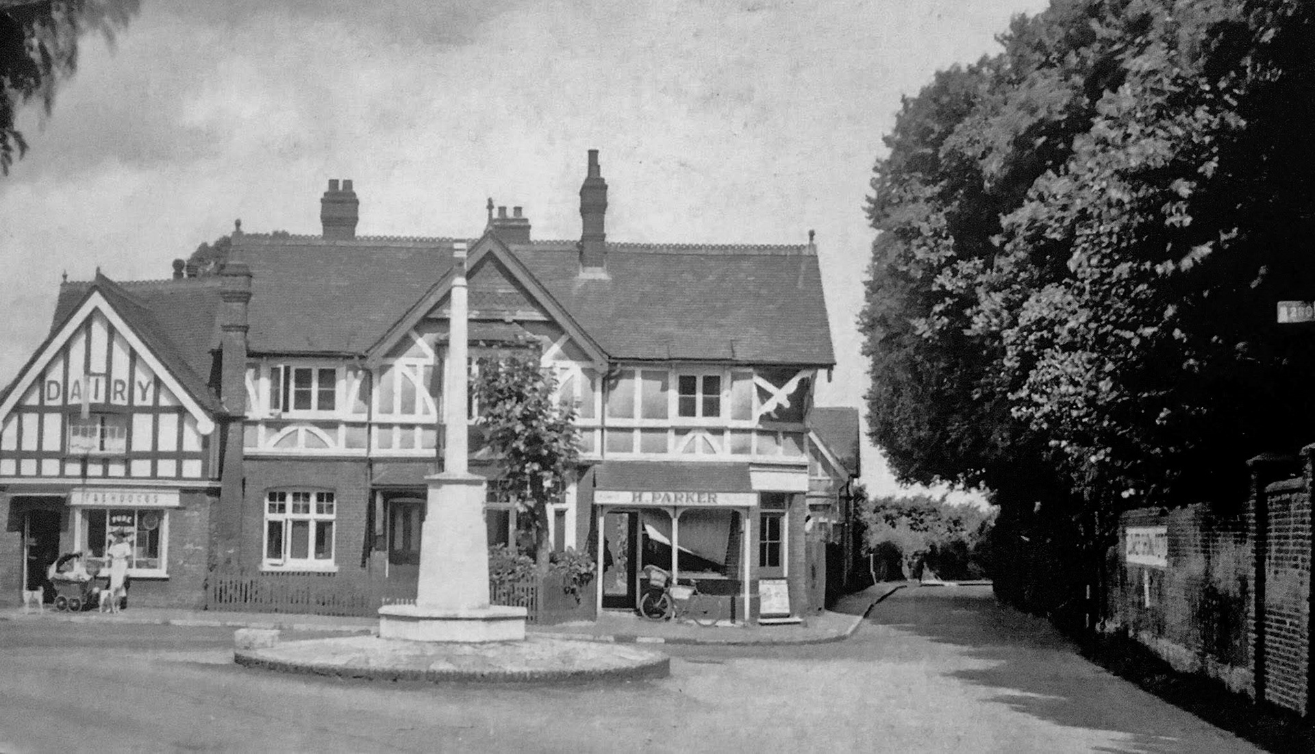 1920s Banstead War Memorial looking north, with Hodges Dairy in the background. Gillian Higgins comments "My grandad worked as the milkman at Hodges. He kept his horse and carT there." (Courtesy Peter Harp, Banstead, Nork &amp; Tattenhams News FB Group)
