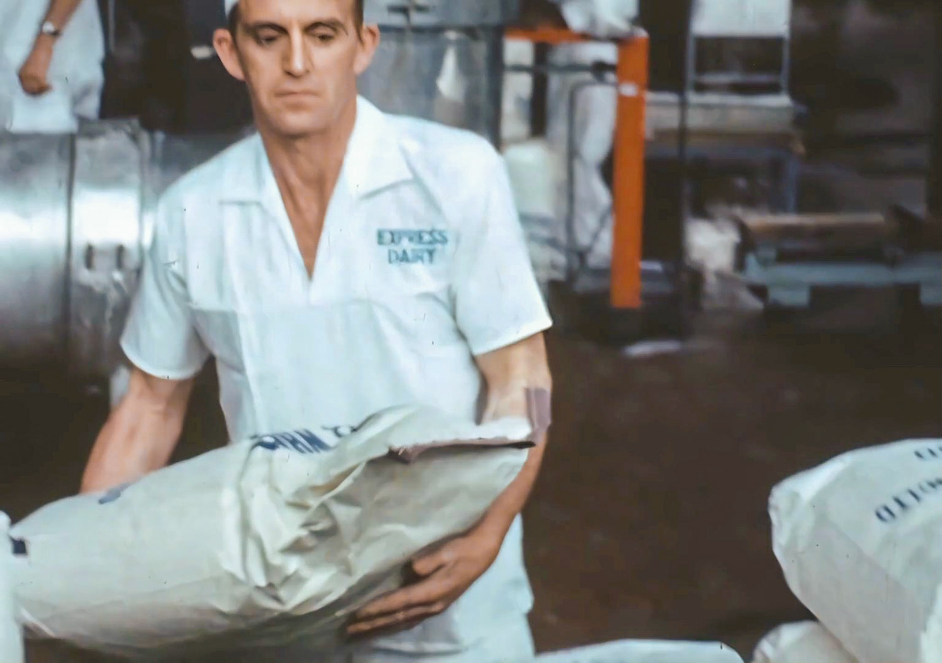 1960's Harold Thompson. Recognised by Fiona Eggleston, Mark Robinson, Sandra Thompson, Jimmy Howard, Kayleigh and Dani Thompson (grandaughters). Sandra comments “Aww bless Harold he was such a lovely man, so lovely to see him as a younger man. Missed by us all.” Jimmy adds “Lovely man, I worked at the dairy with him for years.” (Still from 'The Art of English Cheesemaking' video)