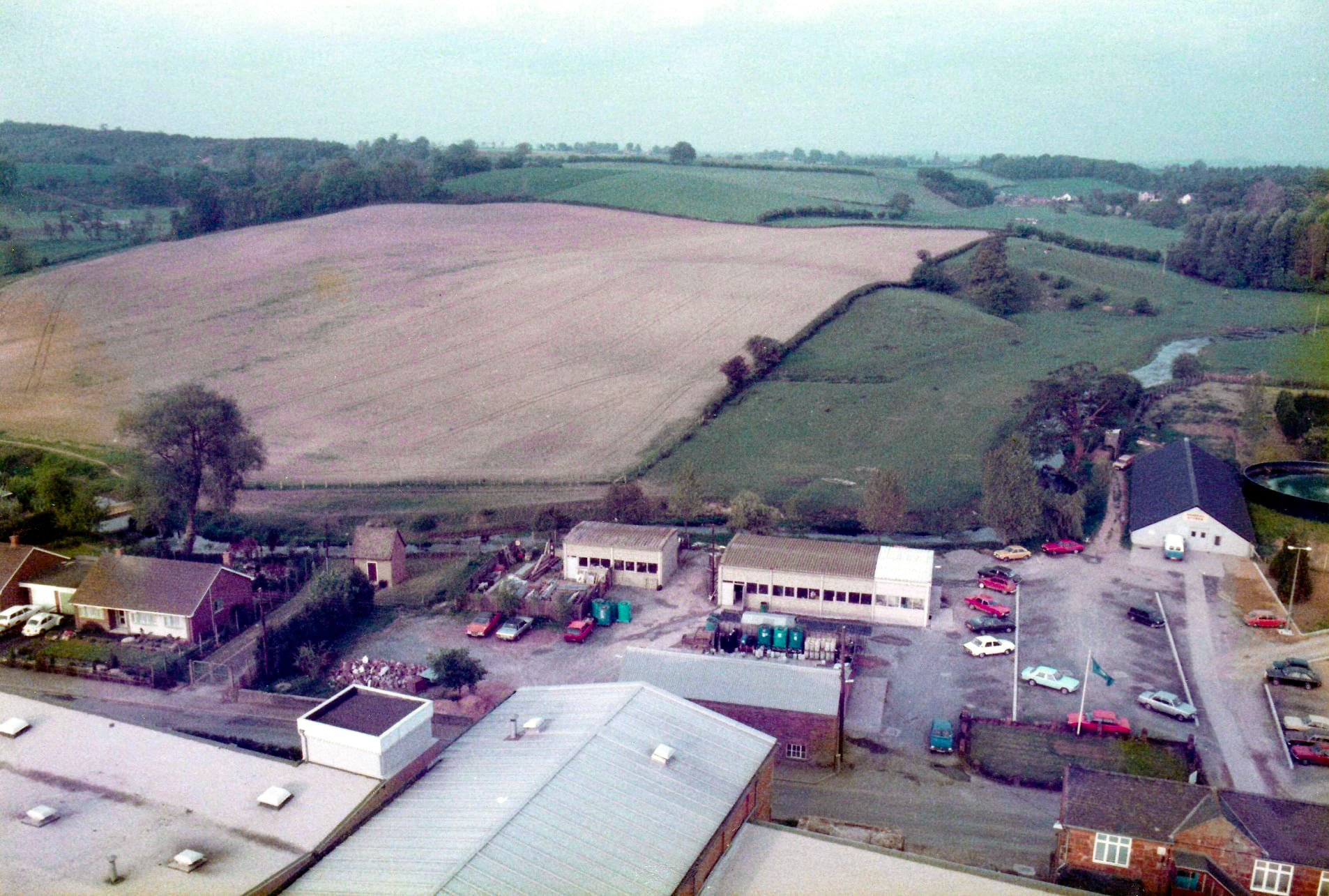 1986 Ruyton. Stephen Graves comments "I climbed inside the newly erected chimney before it was in service and took some panoramic shots from the top. The last picture shows a handrail upright-I'm sure that would have stopped me falling off! The pictures are overlooking the Cheese and Press Rooms and include the Builders Shop, Engineering Workshop, Stores and Effluent Plant. I worked in the Engineering department at the site from 1982-1993 when it closed. Great Times and Great People." (Courtesy Stephen Graves, Ruyton Revisited FB Group)