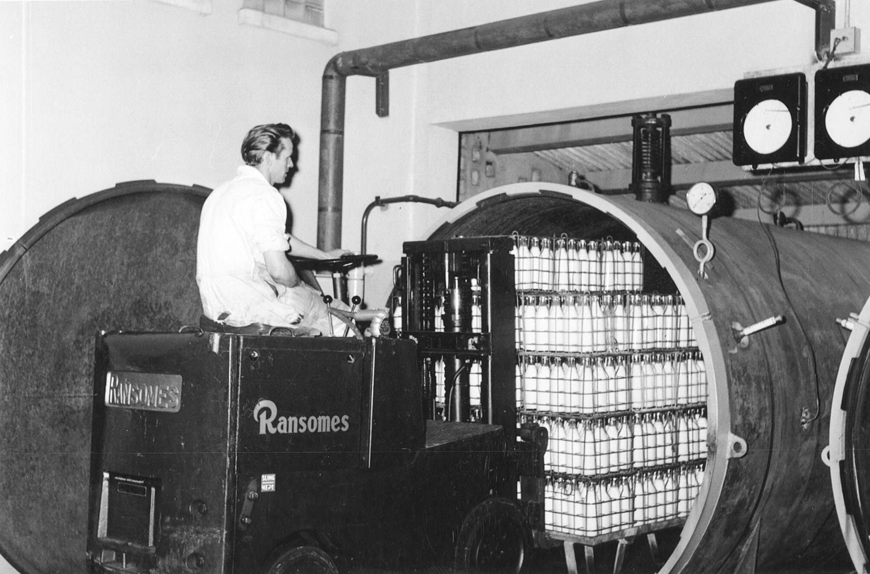 1950s? Unknown location-could be Cricklewood, Nine Elms or Bradford.  Loading sterilised milk into batch steriliser. (Courtesy Dave Fane)