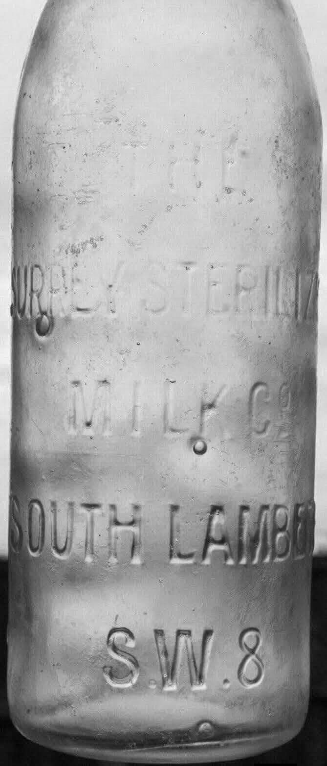 1920s sterilised pint milk bottle embossed with: "THE SURREY STERILIZED MILK CO, SOUTH LAMBETH,S.W.8. On the reverse side near the base: "THIS BOTTLE CONTAINS NOT LESS THAN NINE-TENTHS OF A PINT. William Davis comments "Originally it would have been sealed with a porcelain swing stopper attached by a wire bail. The Surrey Sterilized Milk Co. was based at Nine Elms and was acquired by Express Dairy in the early 1960s." (Courtesy William D.T. Davis)