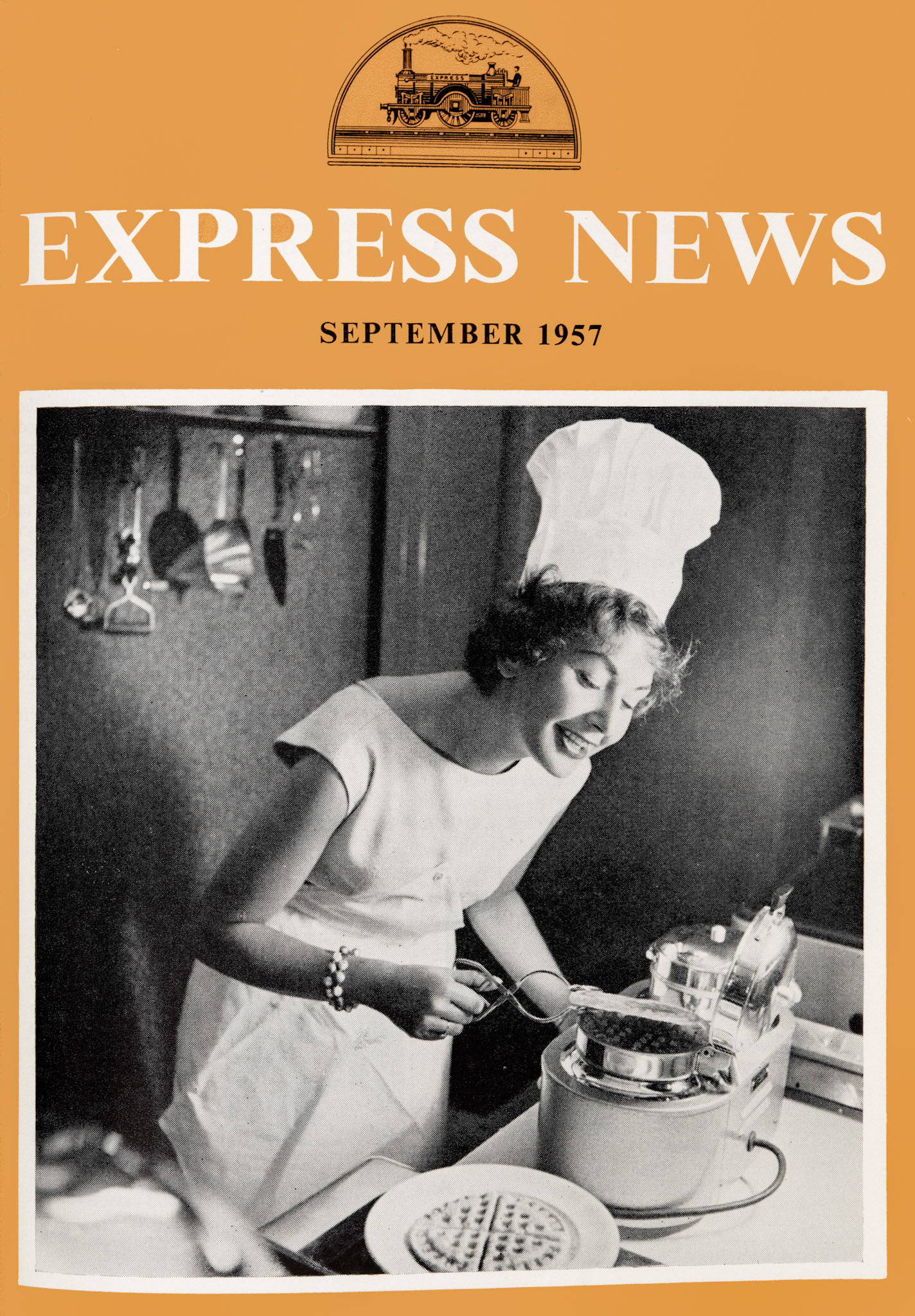 1957 Autumn Front Cover-"Housecraft-Television girl Eve Vitt tries out a waffle-iron in Great Tower Street restaurant."