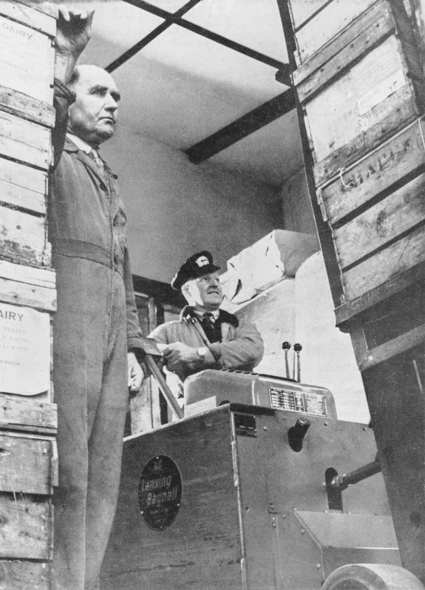 1957 Transport Foreman Mr Bill Cox watches Mr Edgar Harding loading eggs into an articulated truck at Seaton Junction