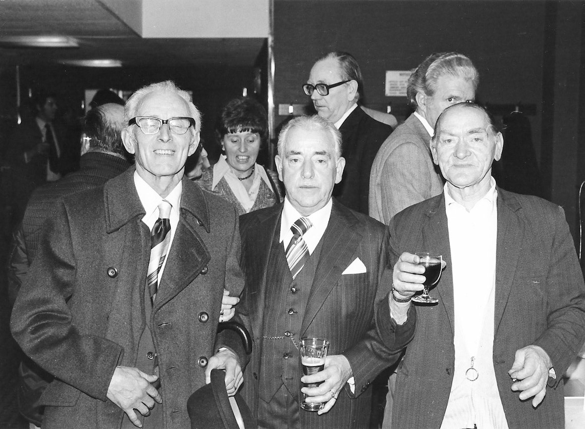 1977 TH Lewis retirees. Brian Wastell comments "This my dad Bob Wastell (centre) on his retirement, with Stan Cardy. On the right of the picture is Stan Loom, painter, who also worked at TH Lewis." (Courtesy Brian Wastell)