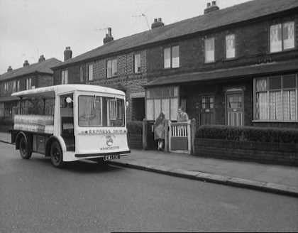 1965 film "Cup Fever". "Children from Barton United are trying to win the local league cup but a local Councillor does his best to ensure that his son’s team wins instead. Skipper and Rocket talk as they help deliver milk. (Naysmith Road in Eccles, with Roby Road and high rise blocks off Cawdor Street in the background.) Rocket delivers more notes advising of the location of the next match. (Shaftesbury Avenue in Eccles) The milkman is asked to help. (Parr Street at the entrance of Lewis Street School with the rear of properties on Renshaw Street forming the background.) A third milkman is asked to join the hunt. (Lewis Street in Eccles) The milkman drives Stopper to the ground. (Edison Road with Shakespeare Avenue to the left.) The floats come to a stand and the missing players rush towards the ground's entrance. (Golf Road with buildings on Moss Lane in the background.) From: https://www.reelstreets.com/films/cup-fever-childrens-film-foundation/