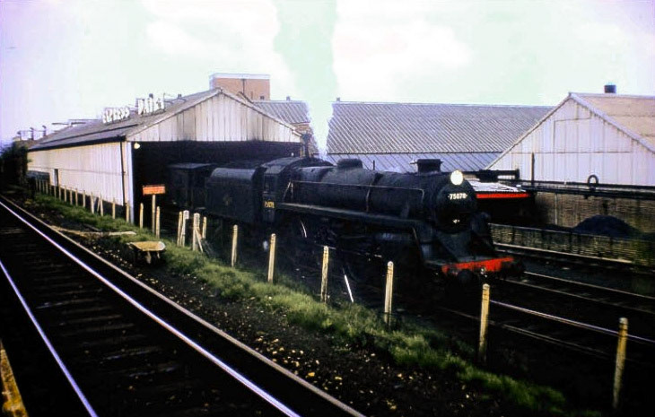 1965 South Morden rail siding, with BR 75078 locomotive. 75078 was built at Swindon in 1956 and as it was built for use on the Southern Region it was fitted with a BR1B tender which had a capacity of 4,725 gallons, because there were no water troughs on the Southern Region. It was equipped with a double chimney in October 1961. (Courtesy Bill Rudd, Mitcham Historical Society)