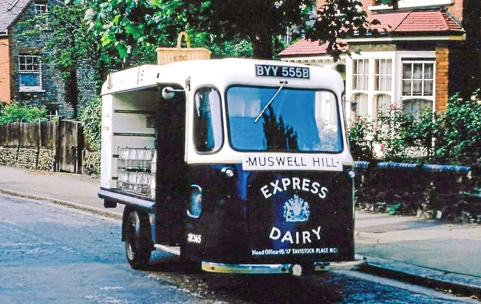 1960's Muswell Hill Reg: BYY 555B. Dave Fane comments "Great picture, just as I remember the Wales &amp; Edwards in the 1960s, no indicators, W&amp;E badge on the front and side and plastic W&amp;E fitting in the middle of the steering wheel." Daral Brennan comments "Living in Woodland Rise N10, we obviously had our milk delivered by Express Dairies in Muswell Hill. They offered more than milk for sale, as anyone who remembers them knows (including bacon, eggs, sausage, bread). A fantastic service for the local community. And of course, paid for at the end of the week - mum loved that! As a kid in the 1960s, their silent milk floats were the first electric vehicles I remember; I found the sound of bottles rattling in their crates outside my bedroom window strangely comforting early in the morning, announcing the start of another day while breaking the silence of the night before". Barbara Ann West adds "Express Dairy at Muswell Hill stabled their milk float horses there. Myself and 3 or 4 other girls of a similar age used to love being at the stables when the horses were being untacked after a day's work and seeing them come alone down the ramp into their stalls to a well earned meal." Ian Pearce remembers "I was a 'milk boy' on one of these - had to help load the crates at the Depot - now the Mussie Well - collect money etc. People often left money on the doorstep rather than be woken early for payment! Different times."  Robert Gee says "I used to work as an milk boy there back in the day, every weekend and more..."