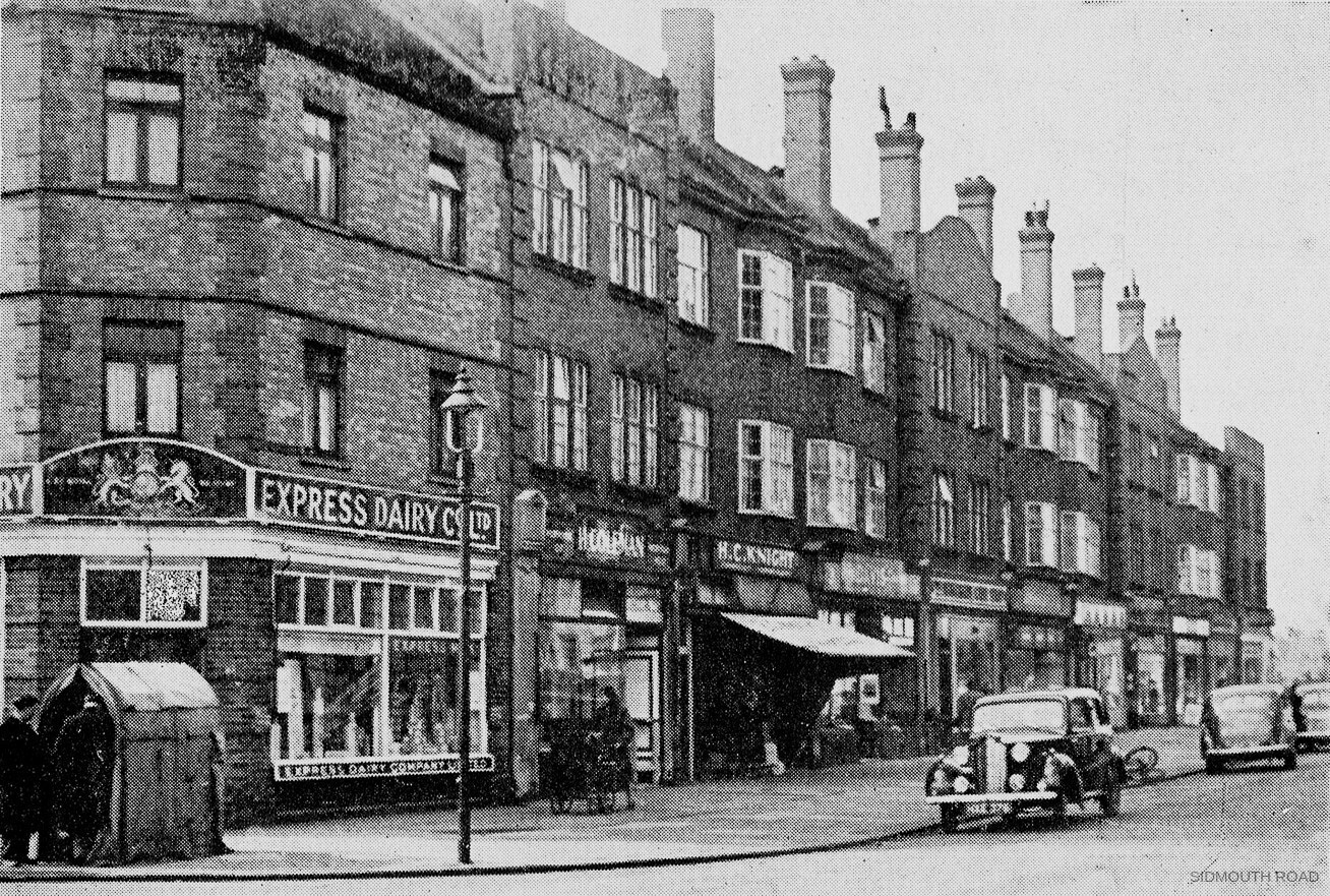 1949 Willesden Shop, Sidmouth Road NW2. Part of a survey of local shopping centres by the Borough of Willesden, described as "A modern shopping parade in Sidmouth Road". Graham Wichall comments "My mum  Jacqueline Tee worked there in the late 30's/early 40's as a milk girl on the horse and cart, with the churns and ladles"Irene Gumm remembers "We lived in Aylestone Ave., and often got a nice chilled carton of milk. Who remembers the milk vending machine outside Express dairy on the Parade?" Alison Harvey comments "We lived round the corner in Chambers Lane. Wasn't there an "iron cow" milk machine outside the Express Dairy?" Vanessa Everitt recalls "When I was a little girl I dropped a jar of jam outside Express Dairy, just minutes after buying it. Burst into tears thinking it was the end of the world, then a lovely man came to my rescue and bought a replacement pot of jam. I never forgot that kind deed, it has stayed with me throughout my life." Alan Port comments "Those were the days... Express Dairies everywhere!!" (Courtesy Robert Russell, Willesden Local History Society)