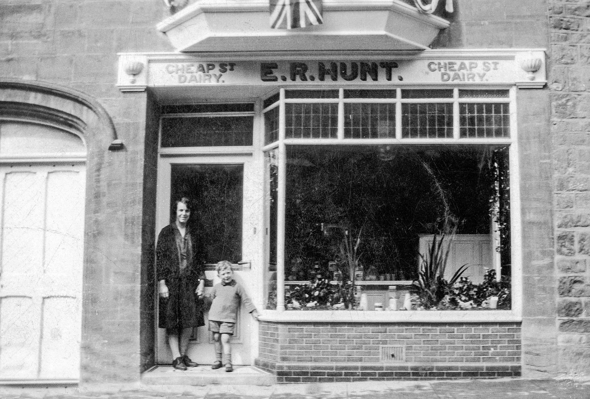 1921 Hunt's Dairy shop. Hunt's Food Group comments "Ralph purchases a property on Cheap Street in Sherborne, once an old fish shop, and transforms it into the new home of Hunt’s Dairies. After marrying Elsie, the couple moved in and began a new chapter together, both in life and in business." (Courtesy Hunt's Food Group FB)