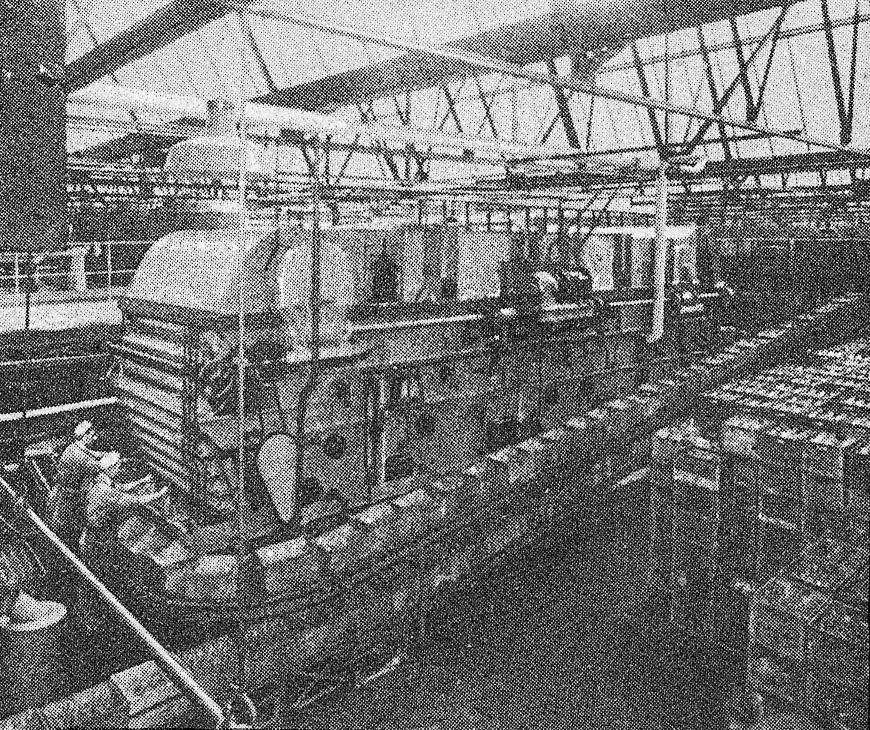 1930's Cricklewood-Bottle Washing Machine, loading. 'A peep behind the scenes of the Express Dairy, Claremont Road, Cricklewood - The largest dairy in Great Britain' (From 'While London Sleeps' booklet.