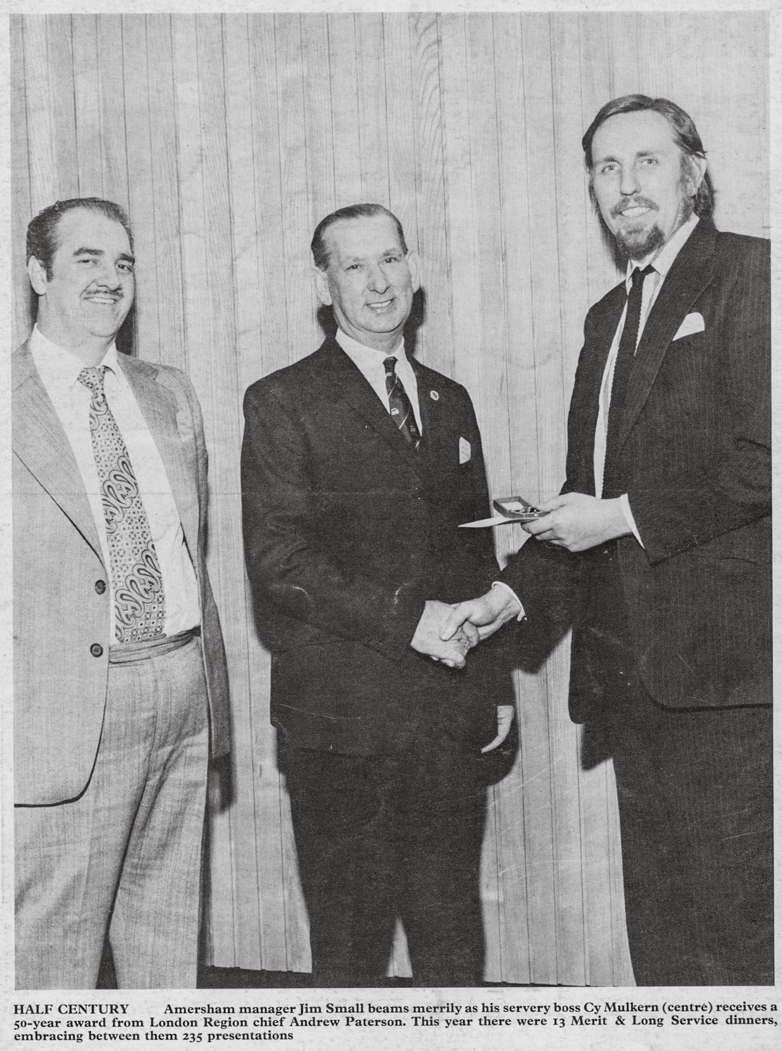 1975 Amersham Manager Jim Small (left) beams as his servery boss Cy Mulkern receives a 50year award from London Region Director Andrew Patterson