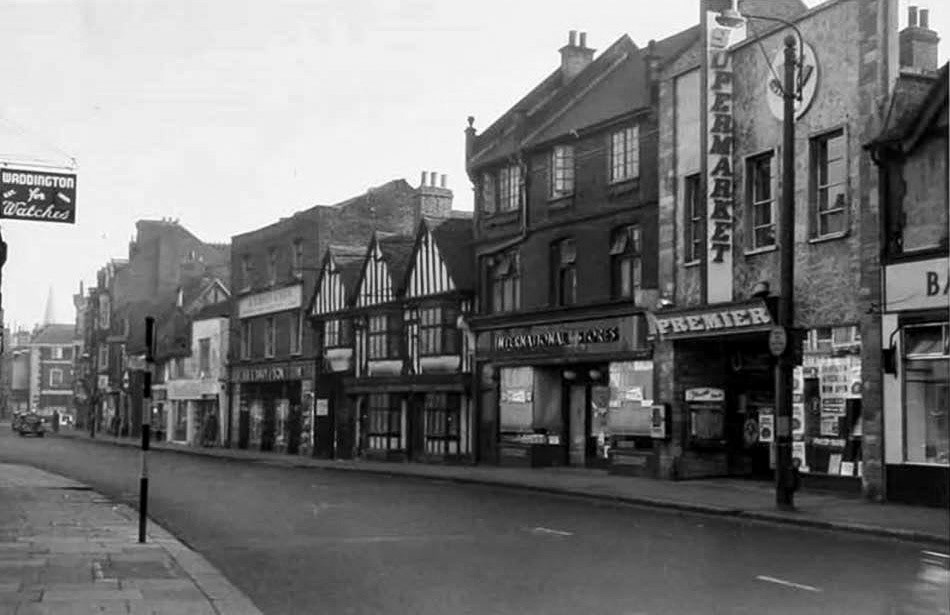 c1960 Premier supermarket, Uxbridge High St, c1960. Richard comments "like the way the word "SUPERMARKET" wraps round the building facia". Ann Lofty comments "Love it-I started work in Premier Supermarket when I was sixteen in 1958 as checkout chick." Diane Klaw comments "I worked there, Friday evening and all day Saturday, whilst still at school in the late 50's. I absolutely loved it. My job was packing people's bags on No.1 checkout. Stella was on No.2 checkout. We had conveyor belts sending the shopping down to us. They offered me a full time job when I left school, but I was offered a job as Receptionist at Fassnidge, Son and Norris, another wonderful job, with a superb company,❤️" Roger Tuffin remembered "I used to mop the front entrance every morning and just spot clean the floors in about 67/68 before I went and did my proper job-started about 6.30am." John Grafham remembers "They had a nice café, and also Premier was the first place I ever saw pick n mix! I worked Saturdays at Foster Brothers just a bit further along the High Street. Lovely memories!" Christopher Carter adds "Premier store, later to become the library." (Courtesy Richard Gaylard)