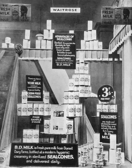 1930 BD milk from Bladen Dairies, Milborne St Andrews on display at early Waitrose shop. 'Your grocer your milkman'. Illustration from 'Modern Grocery Display, A Practical Work on Window Dressing and Interior Display' edited by C L T Beeching (Caxton, c 1930) Waitrose was founded in 1904 by Wallace Waite, Arthur Rose and David Taylor, Waitrose &amp; Partners began as a small grocery, Waite, Rose &amp; Taylor, in Acton, West London. In 1908, two years after David Taylor had left the business, the name "Waitrose", from the remaining founders' names, was adopted.